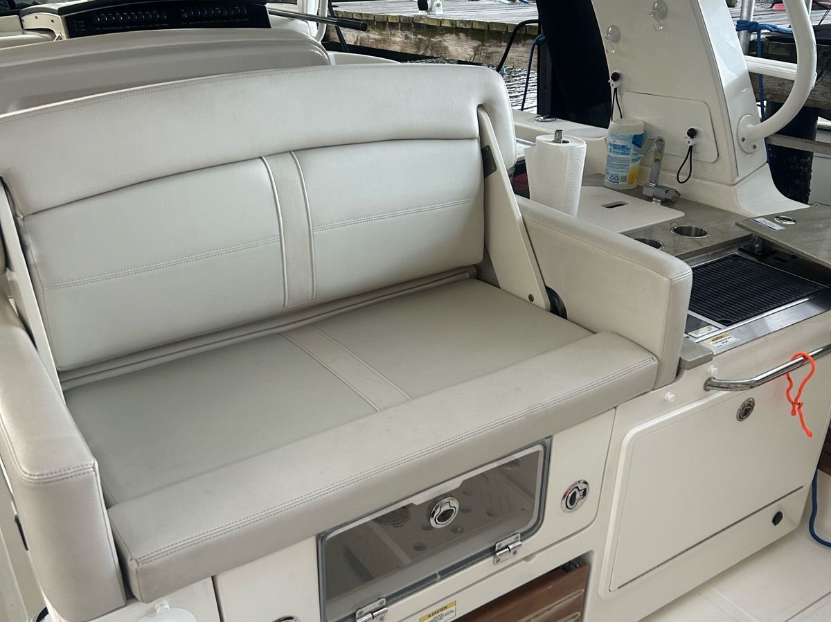 The 2021 Boston Whaler 350 Realm features a comfortable bench seat and a well-equipped kitchenette.