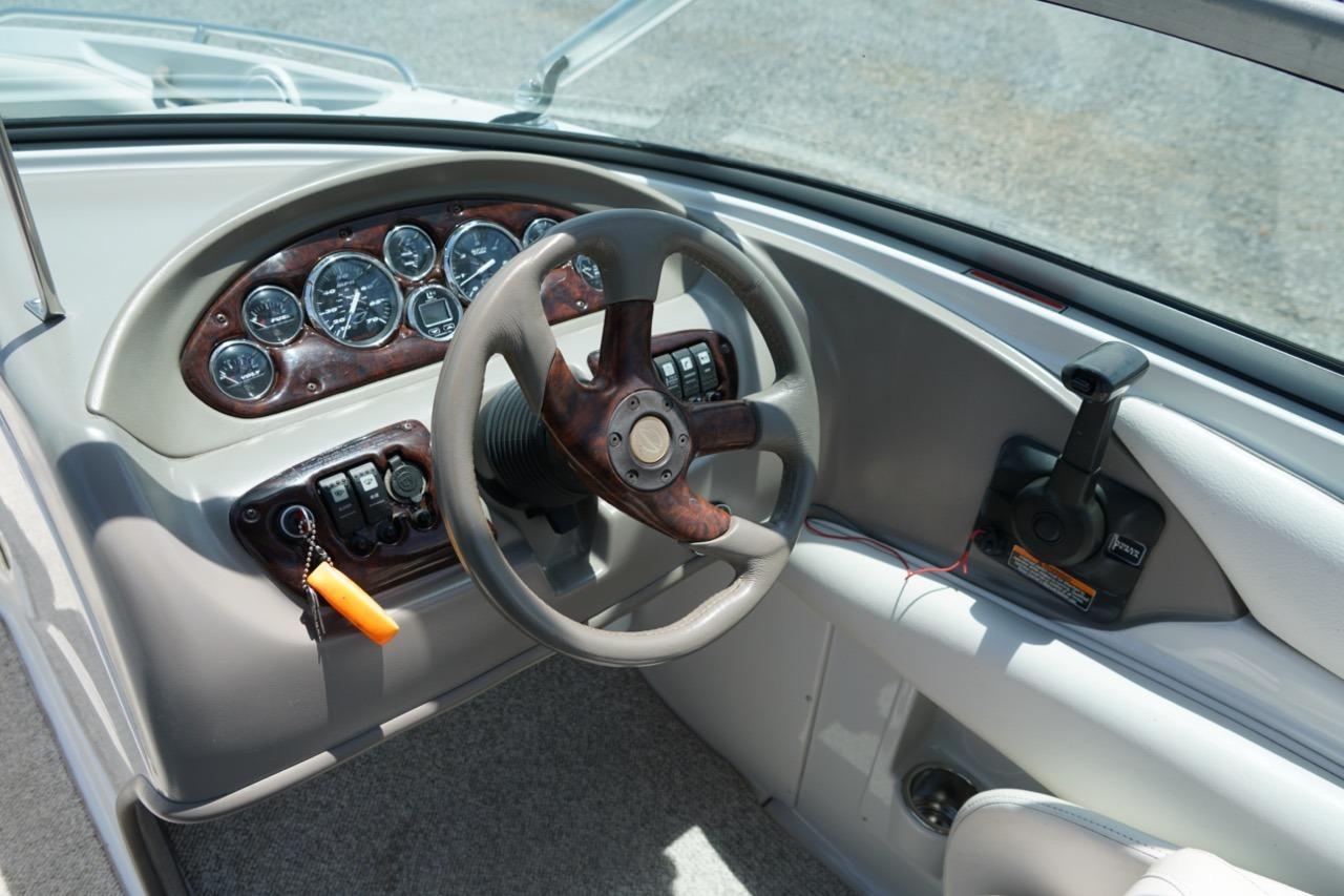 2004 Crownline 216 LS boat dashboard with steering wheel and instrument panel.