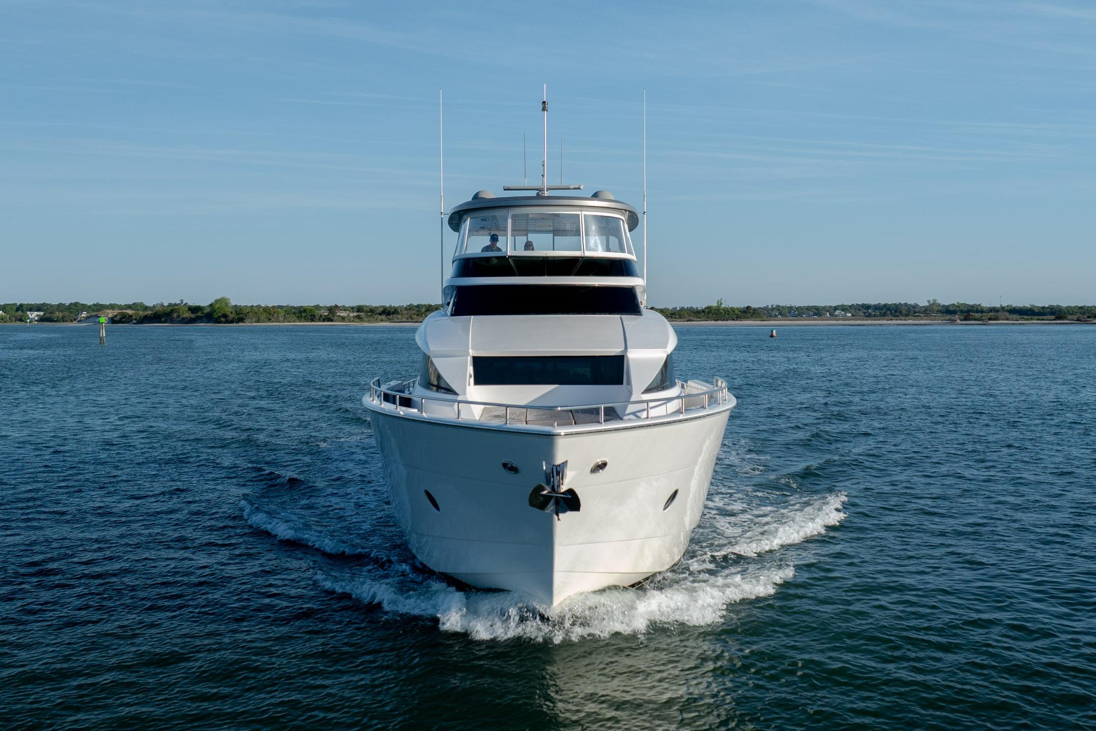 Front view of a 2017 Hatteras M75 Panacera yacht cruising on open water.
