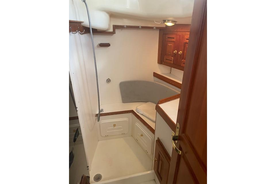 Interior of 2001 Tartan 3700 sailboat with wooden cabinetry and seating area.