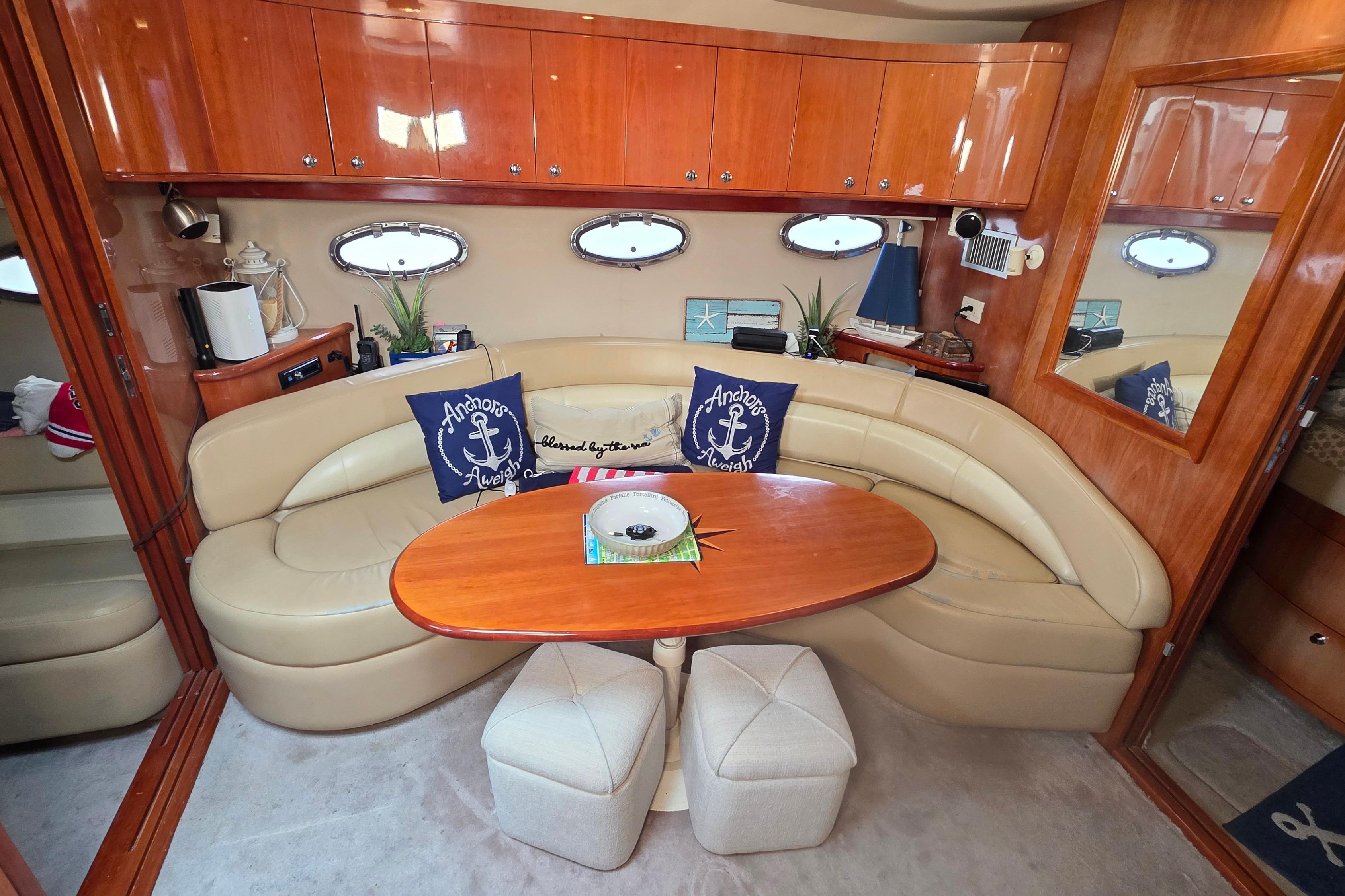 Luxurious interior of 2002 Regal Commodore 4260 yacht with leather seating and wooden accents.