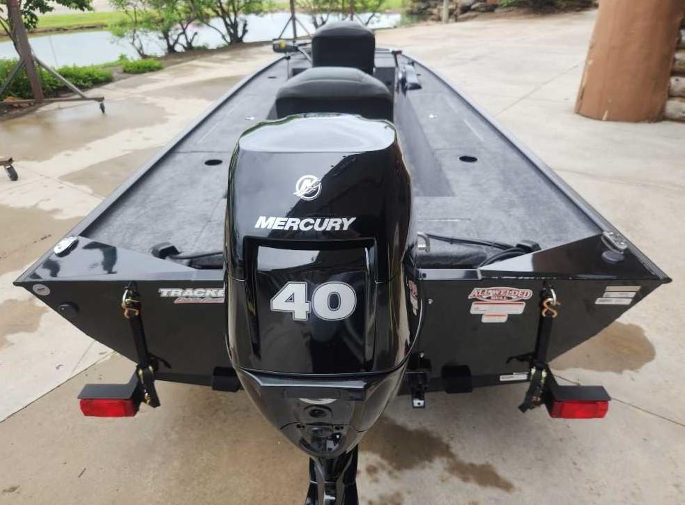 2025 Tracker Panfish 17 boat with Mercury 40 outboard motor, parked on concrete.