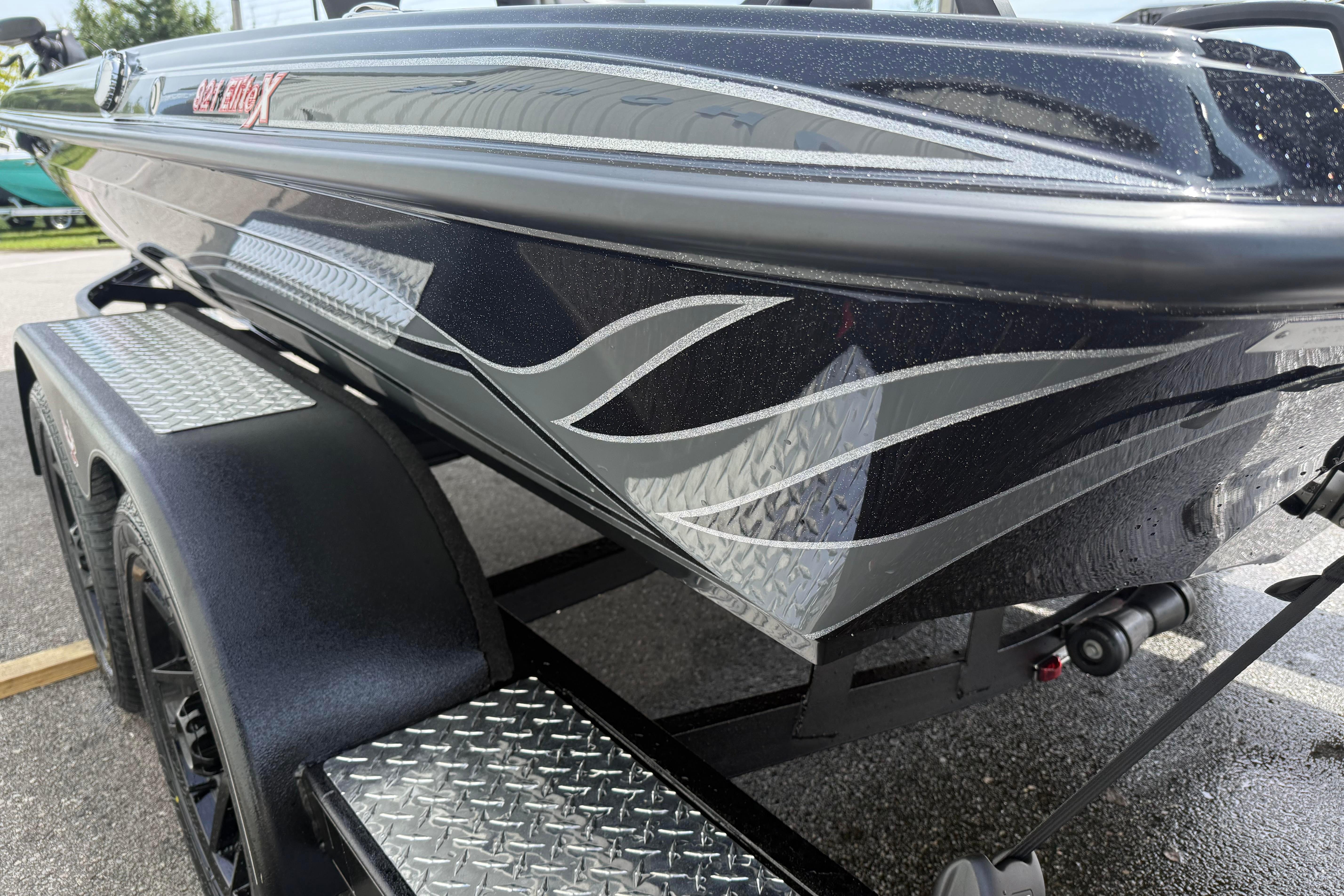 2027 Phoenix 921 Elite X boat with sleek design and custom graphics on a trailer.