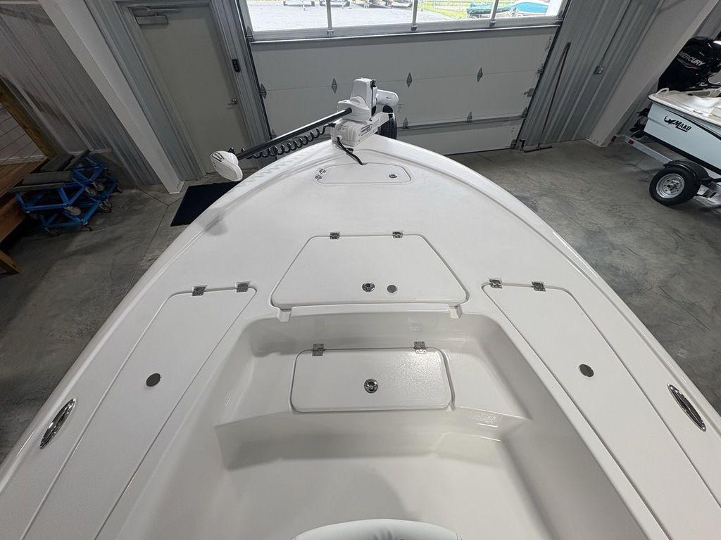 2026 Tidewater 2110 BM boat interior with storage compartments in a showroom.