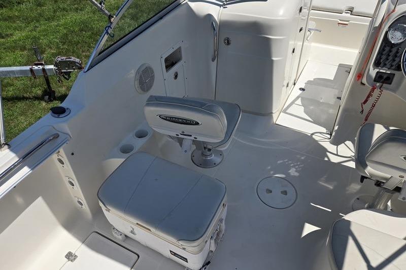2004 Aquasport 215 Osprey Sport boat interior with seating and control panel.