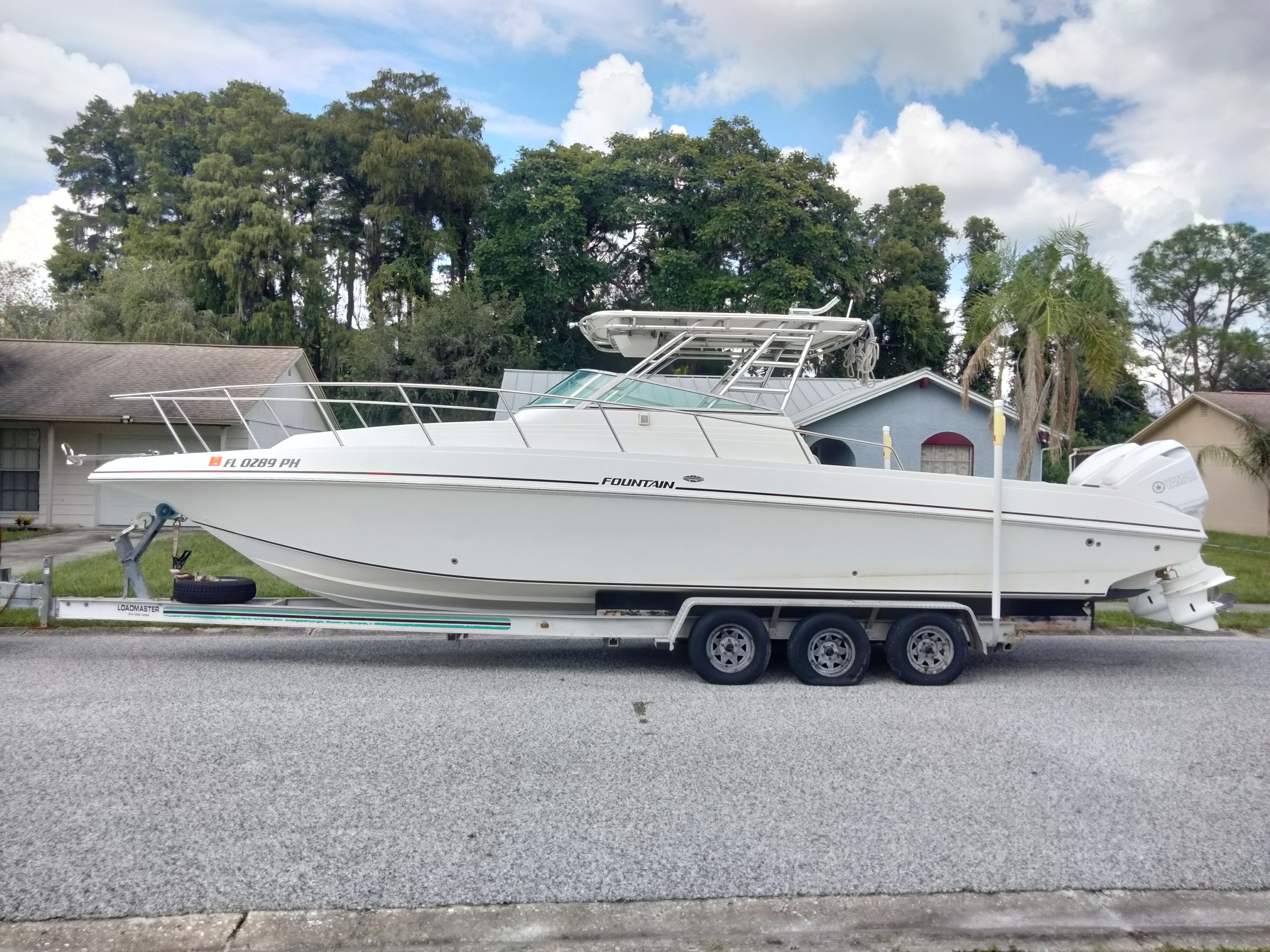 1995 Fountain 31 SFC on a trailer in a residential area.