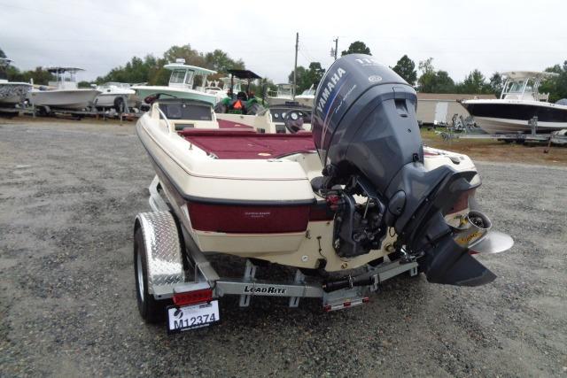 1996 Quantum 180 XD boat with Yamaha outboard motor on a trailer, parked in a gravel lot.