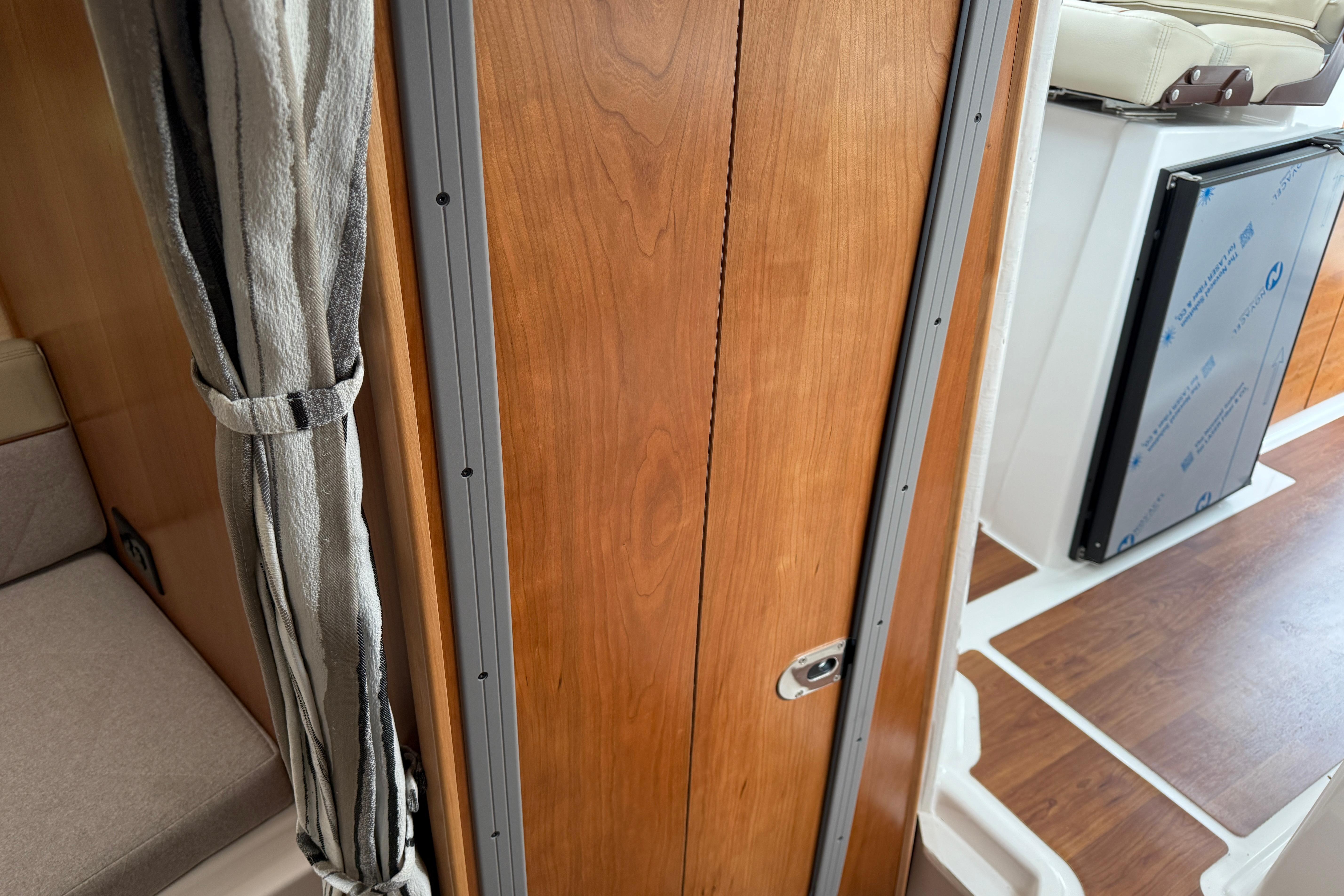 Interior view of 2026 Cutwater C-248 Coupe, featuring wood paneling and seating area.
