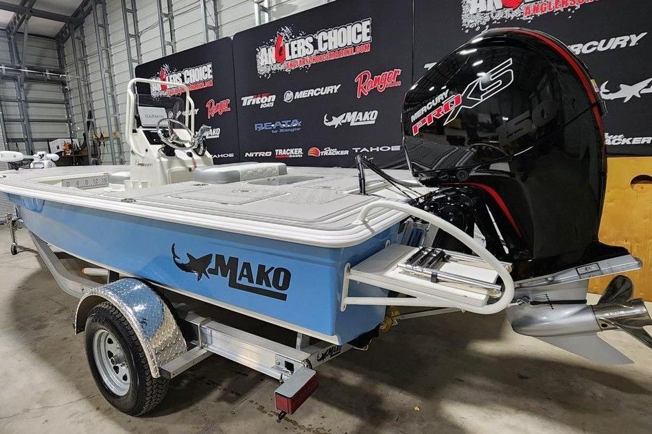 2026 Mako 18 Pro Skiff boat with Mercury Pro XS engine in showroom.