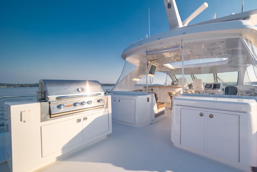 Luxurious 2008 Hatteras 72 Motor Yacht with outdoor grill and spacious deck.