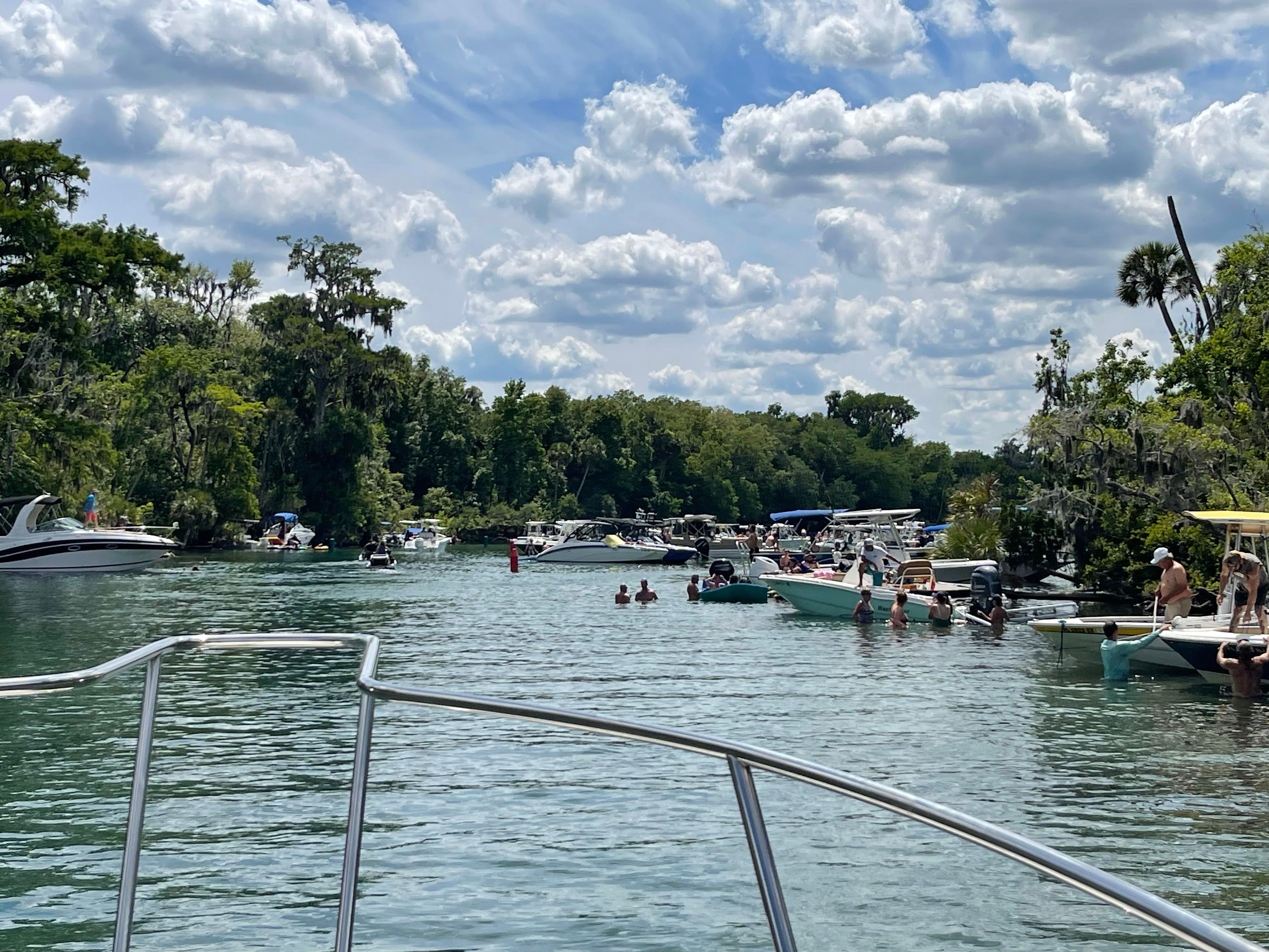 Boats and people on a river, Boston Whaler 235 Conquest, 2010.