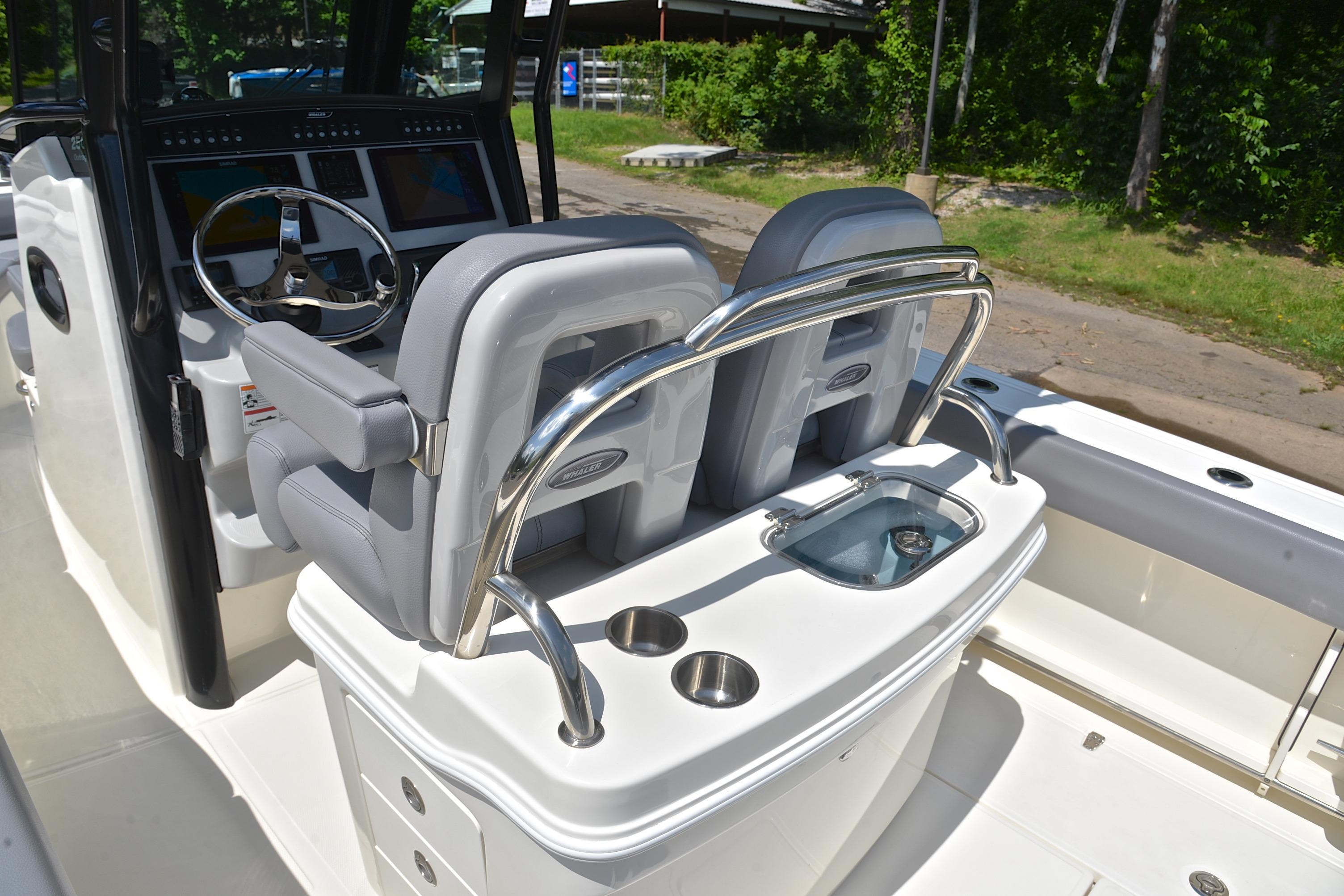 2024 Boston Whaler 250 Outrage helm with dual seats and modern controls.