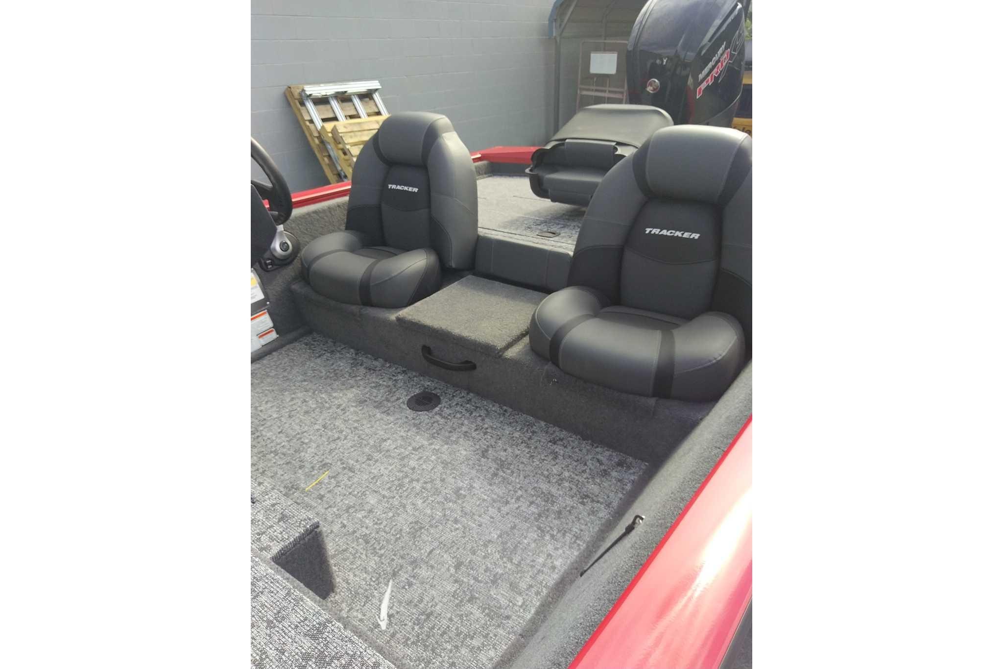 2026 Tracker Pro Team 190 boat interior with black seats and carpeted flooring.