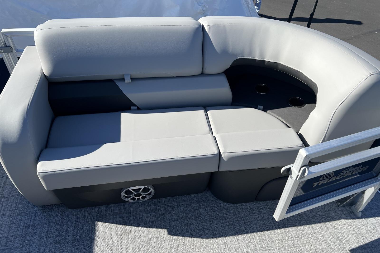 2026 Sun Tracker SportFish 22 DLX boat seating with gray upholstery and cup holders.