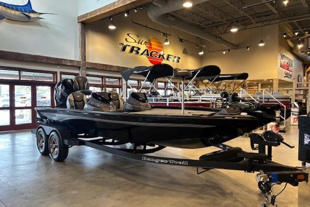 2025 Ranger ALPHA 208 boat displayed in showroom, featuring sleek black design and modern amenities.