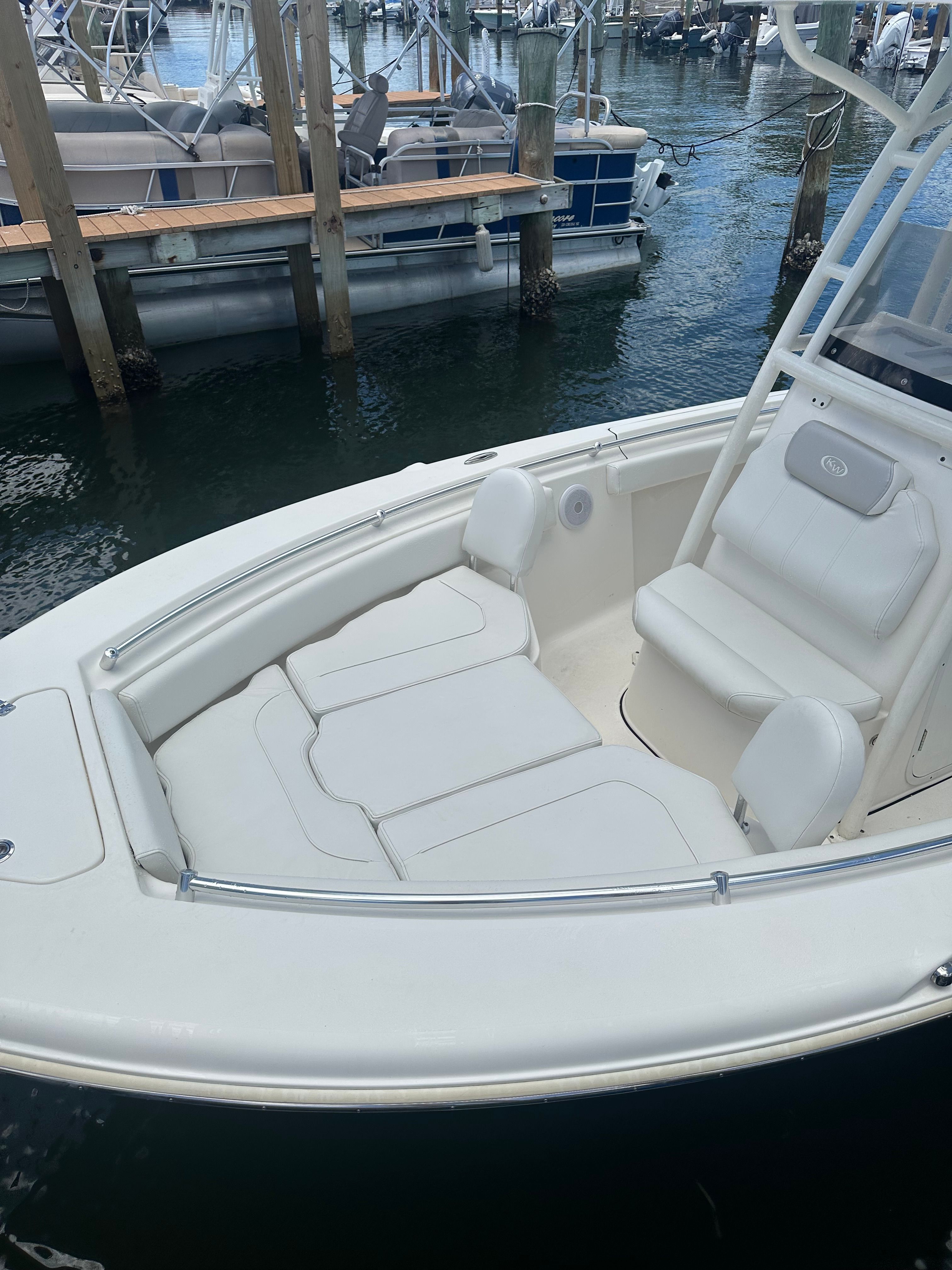 A Key West 219 FS boat is docked in the water.