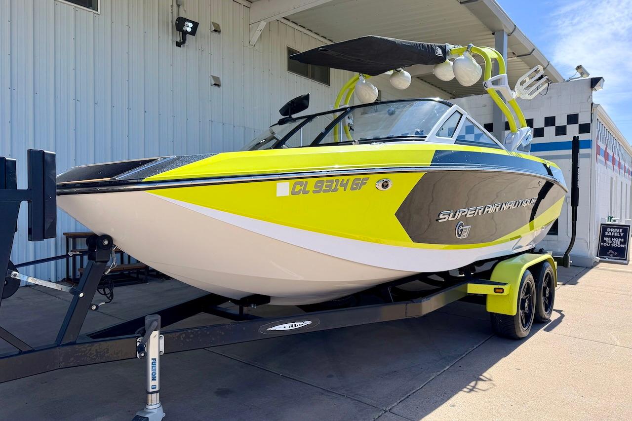 2014 Nautique Super Air Nautique G21 boat in vibrant yellow on trailer.