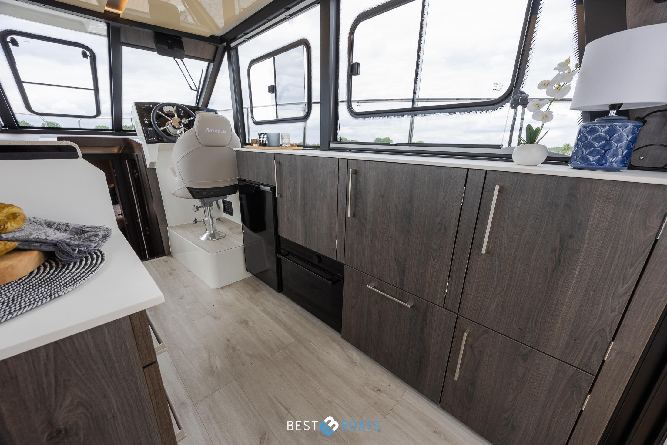 Interior of 2023 Cobra Yachts Futura 36 Premium Fly, featuring modern helm and cabinetry.