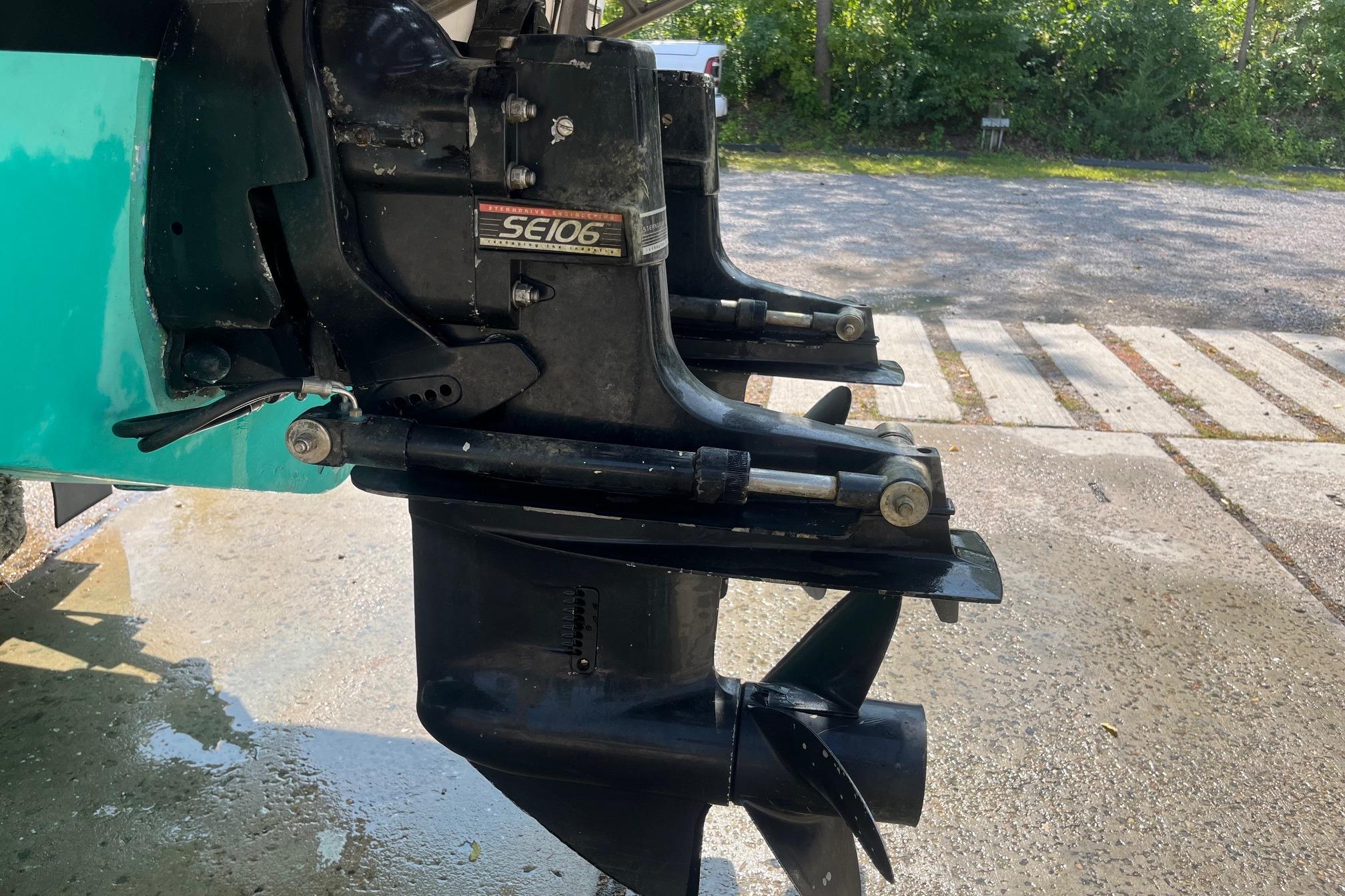 1975 Bertram 26 Moppie boat engine with SE106 outdrive, parked outdoors.