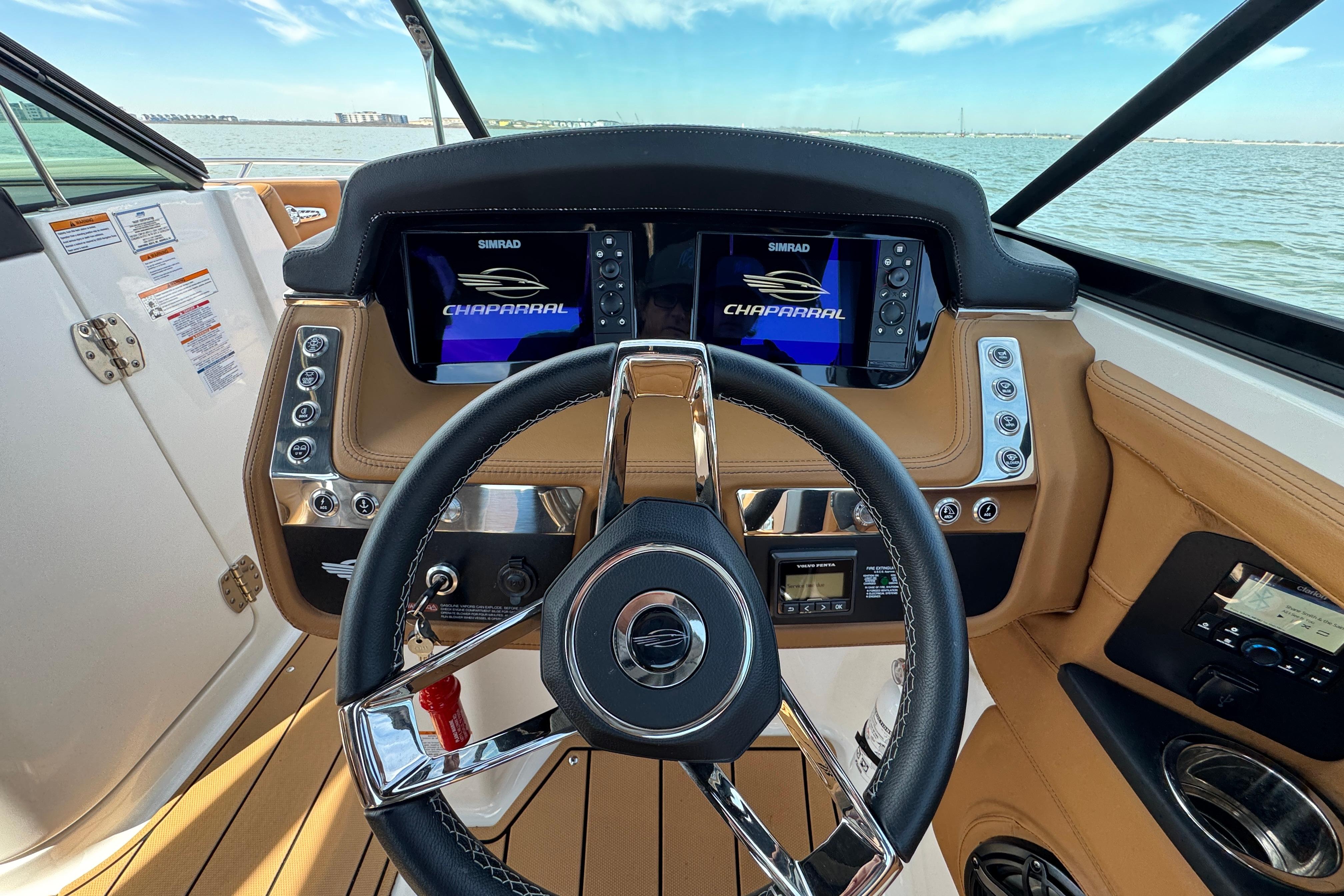 2023 Chaparral 26 Surf boat dashboard with dual Simrad displays and leather accents.