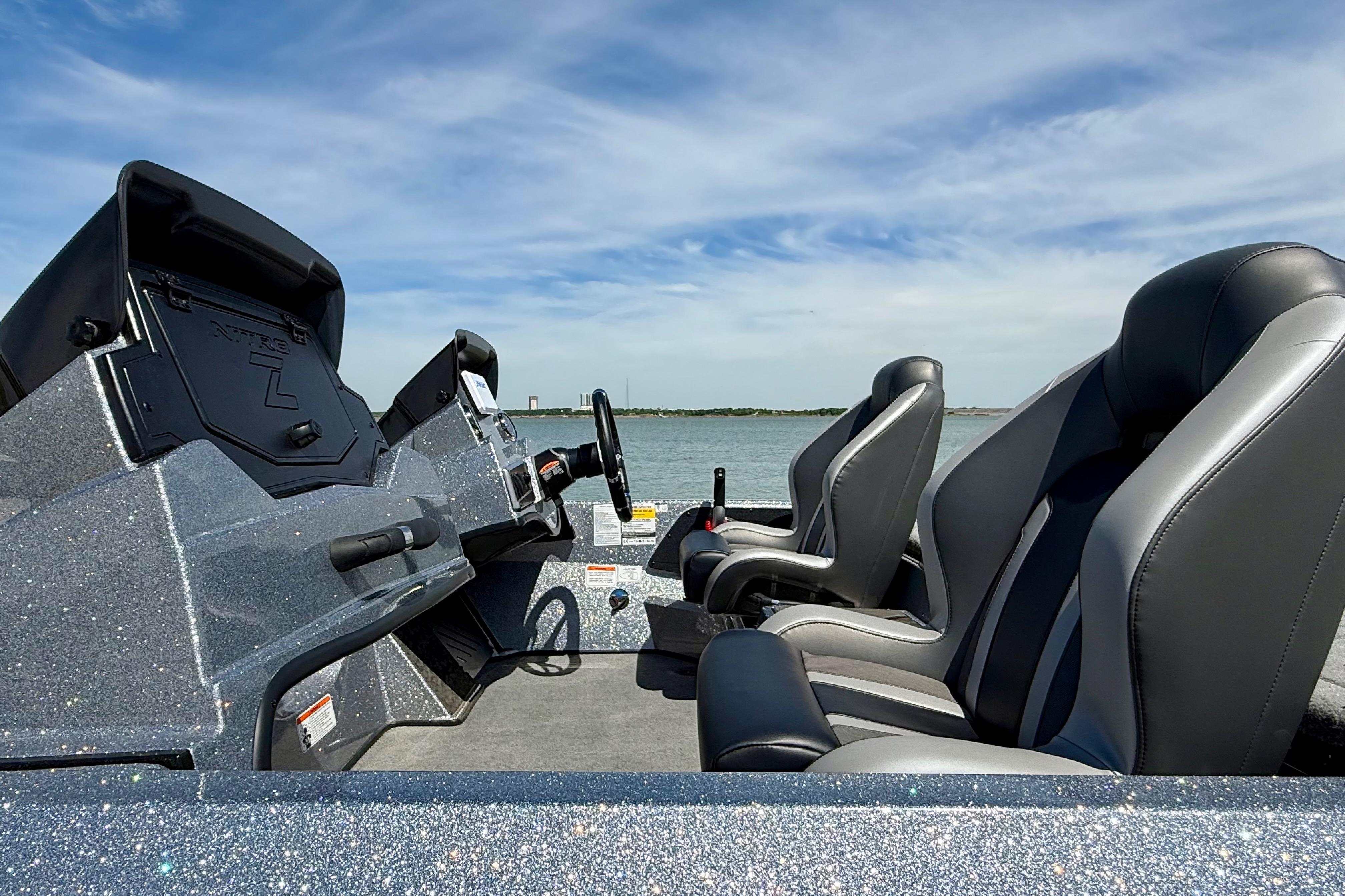 2026 Nitro Z19 XL boat interior with sleek seats and modern dashboard on a sunny day.