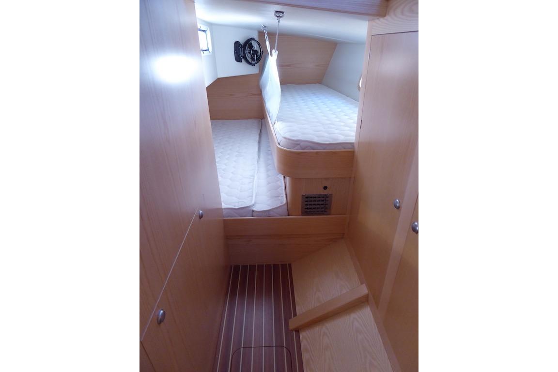 Interior cabin of 2017 Boreal 47 yacht with wooden finish and cozy bedding.