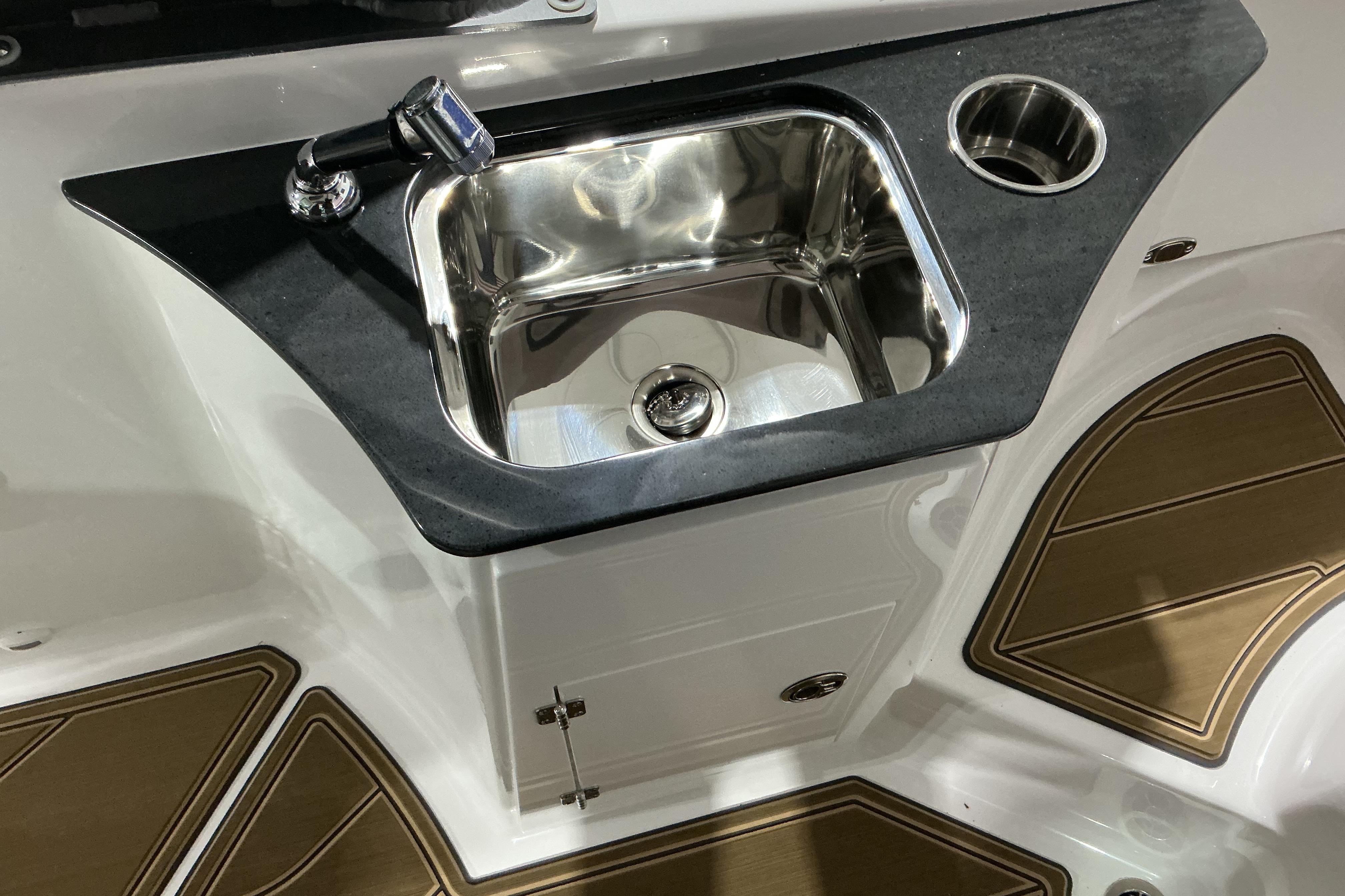 2026 Monterey Elite 25 OB boat sink with faucet and cup holder.