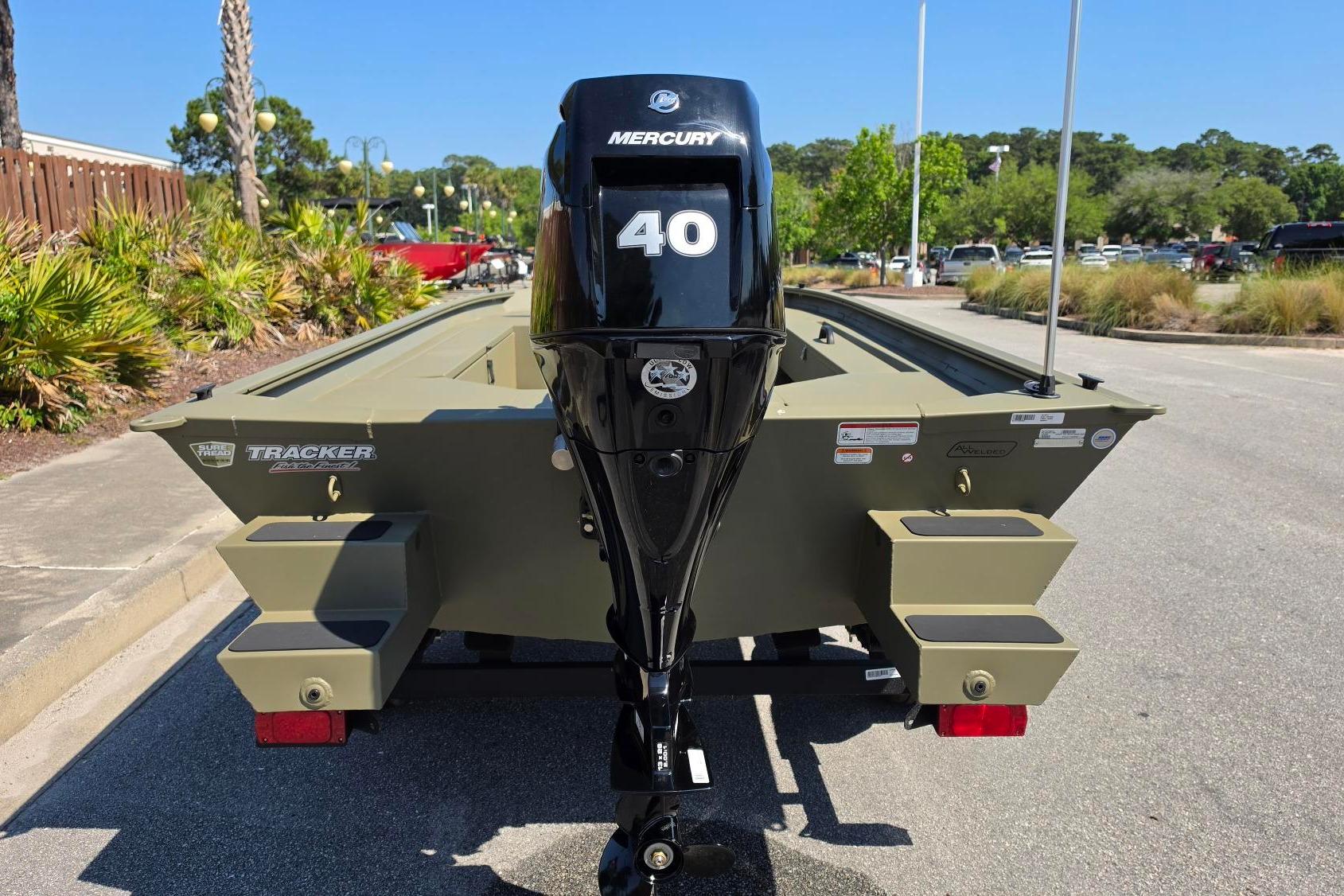 2026 Tracker Grizzly 1654 T Sportsman boat with Mercury 40 engine, parked outdoors.