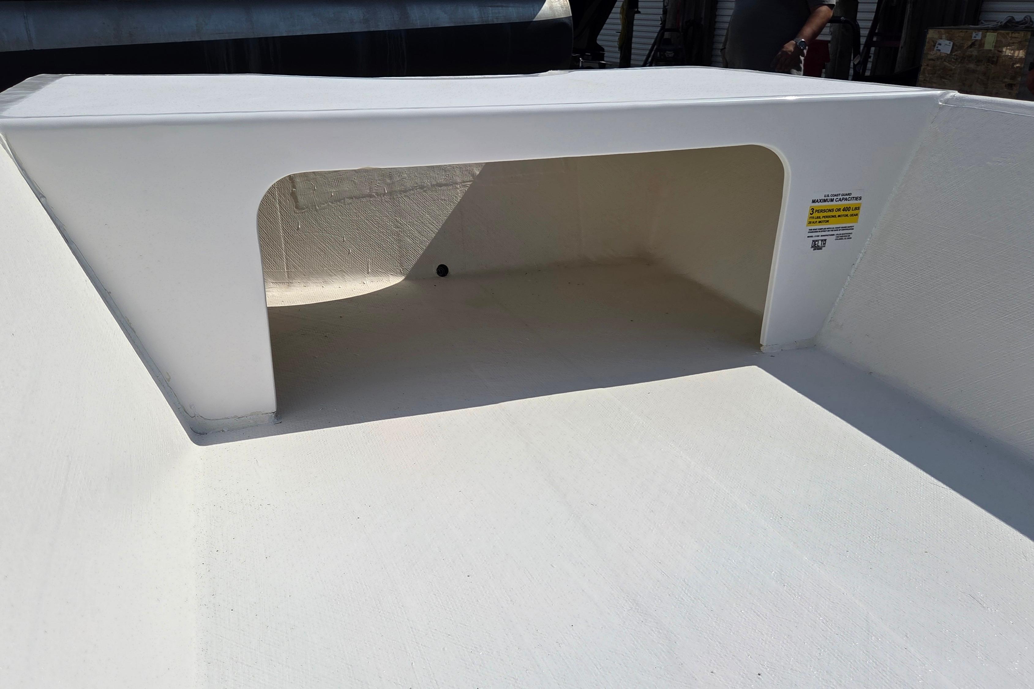 Open storage compartment on a 2027 Delta Boatworks 1550 boat deck.