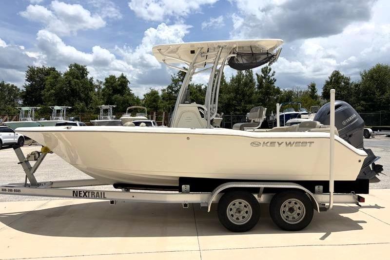 2023 Key West 203 FS boat on trailer, parked outdoors under cloudy sky.