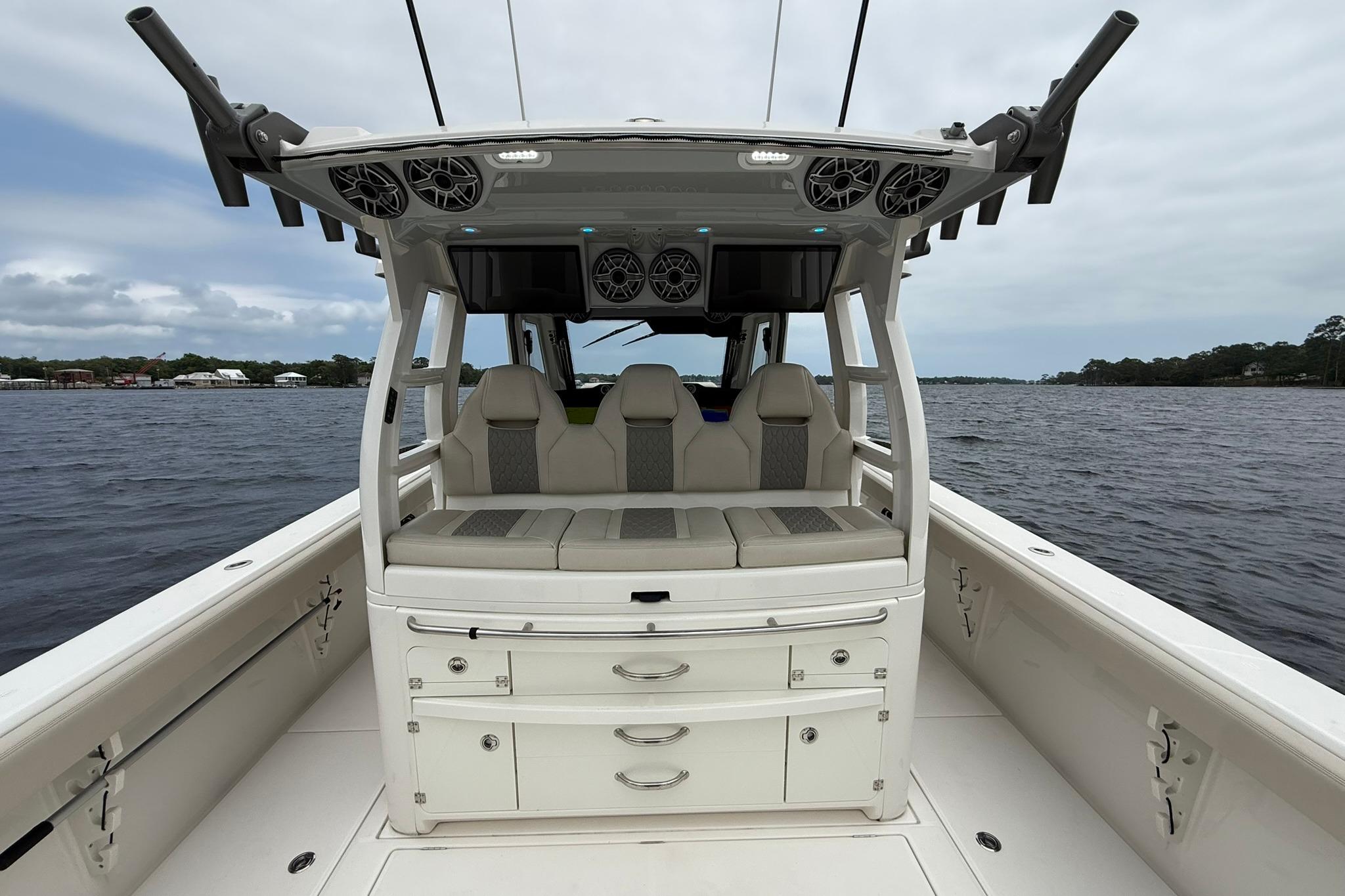 2022 Solace 41CS boat interior with seating and storage, on a calm water backdrop.