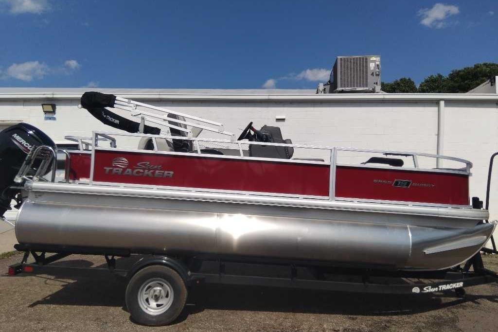 2026 Sun Tracker Bass Buggy 18 DLX pontoon boat on trailer, red and silver design.
