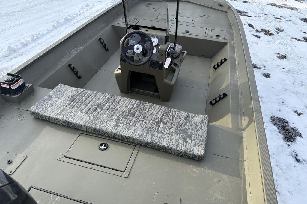 2026 Tracker Grizzly 2072 CC boat interior with steering console and camouflage seating.