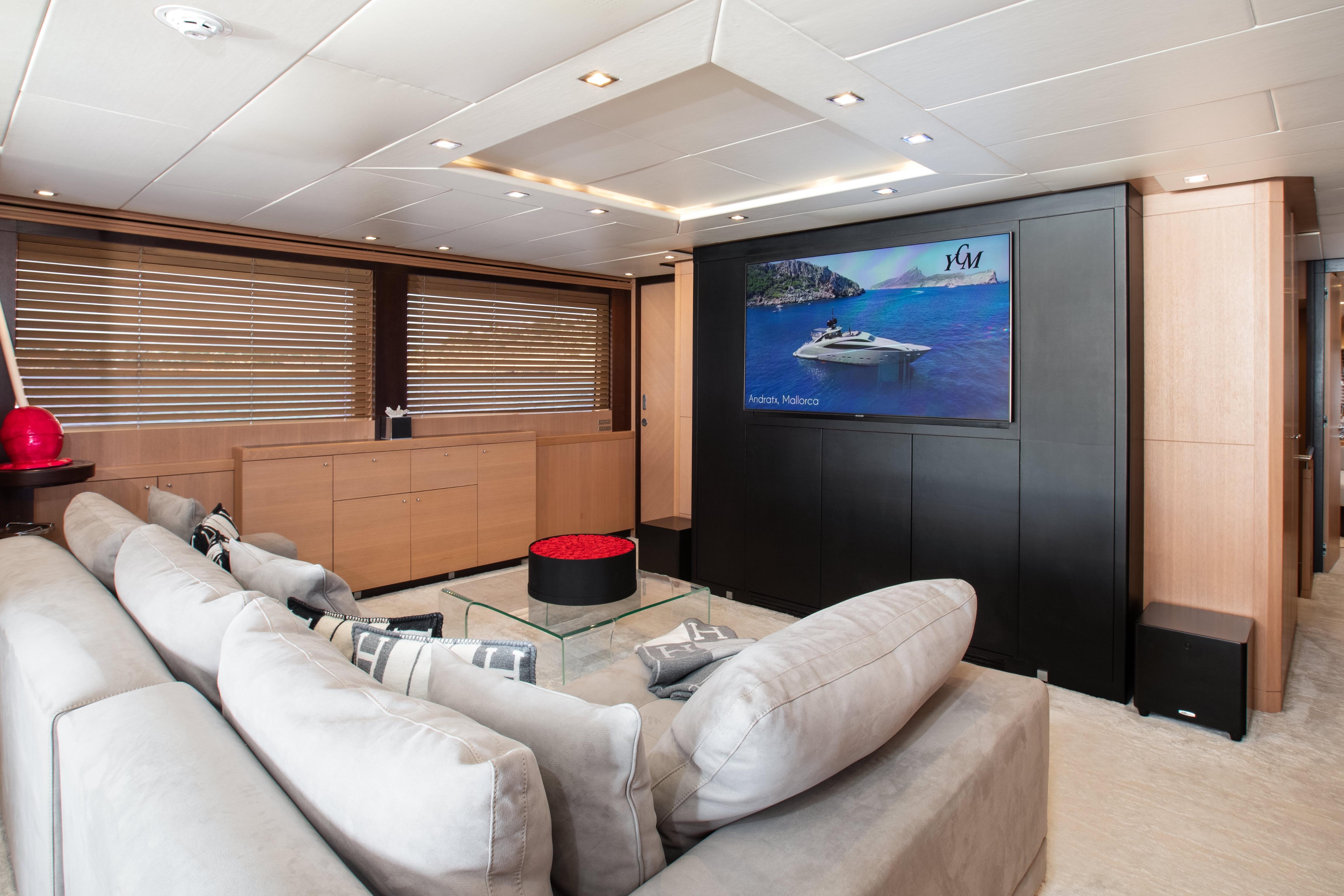 Luxurious yacht interior with plush seating, large TV, and modern decor, ISA 120, 2006 model.