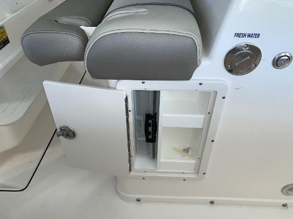 2024 Key West 263 FS boat interior storage compartment with fresh water access.