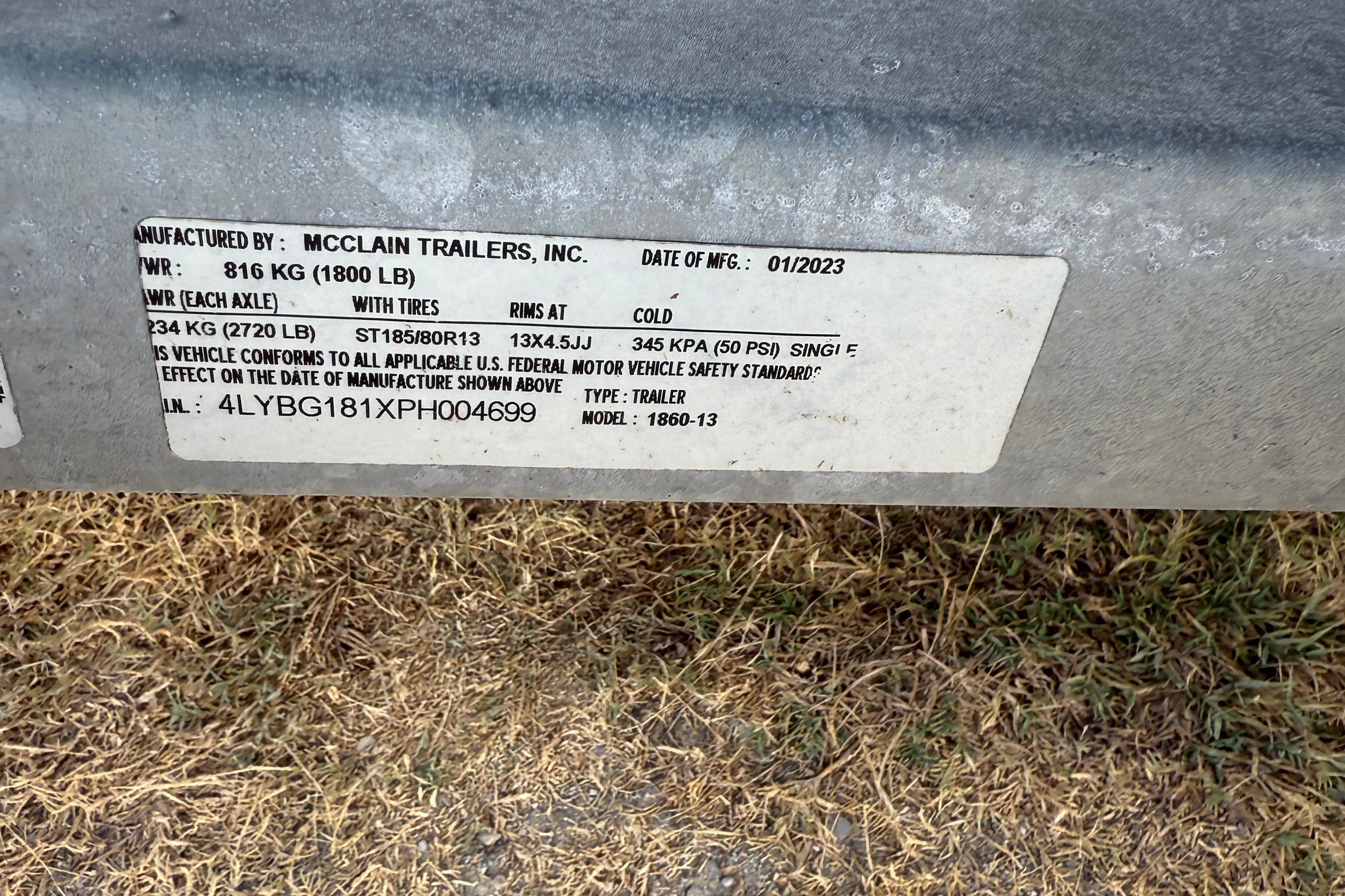 Label on McClain trailer, manufactured 01/2023, showing weight and tire specifications.
