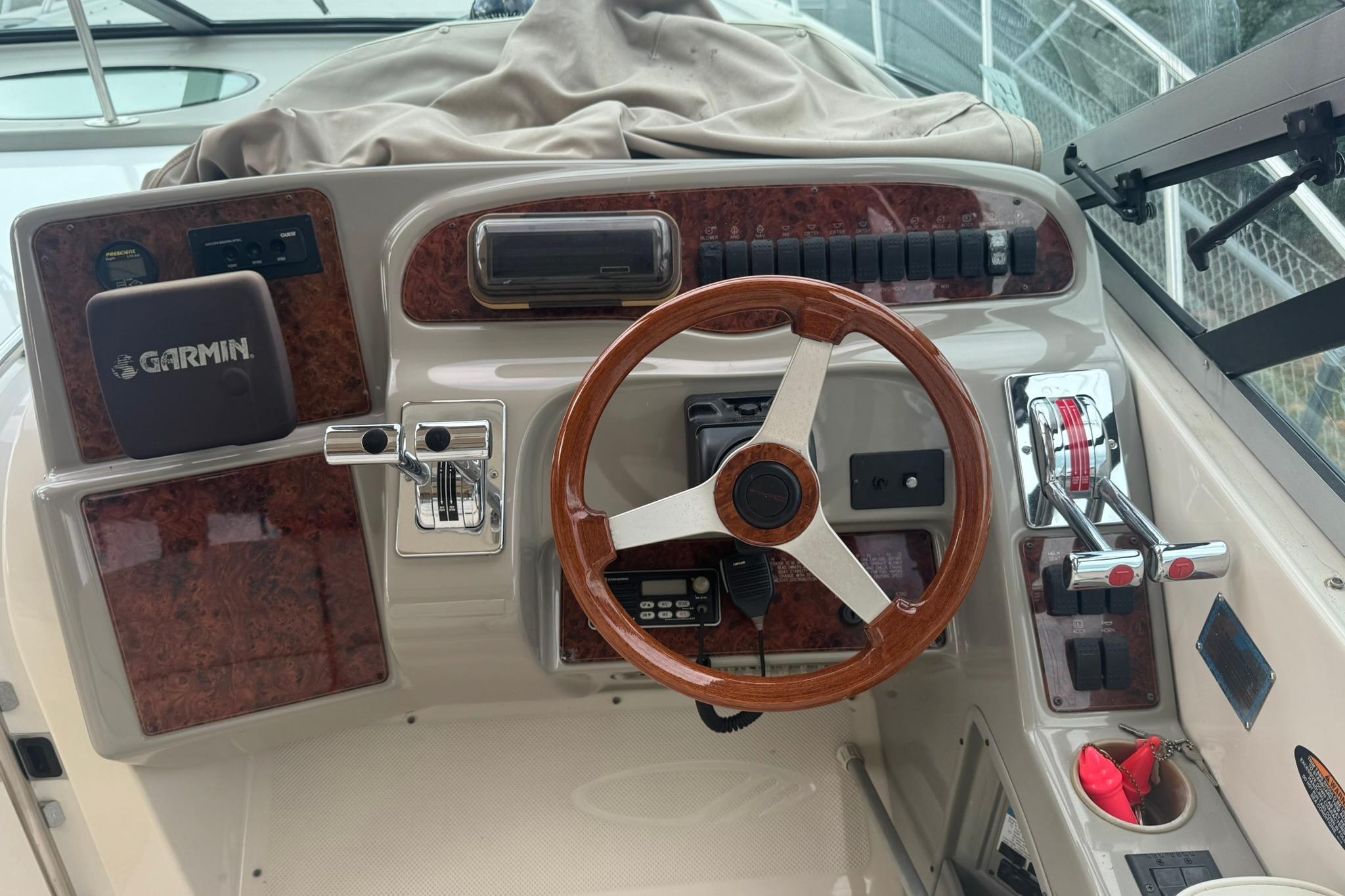 1998 Maxum 3700 SCR boat helm with Garmin navigation, wood steering wheel, and control panel.