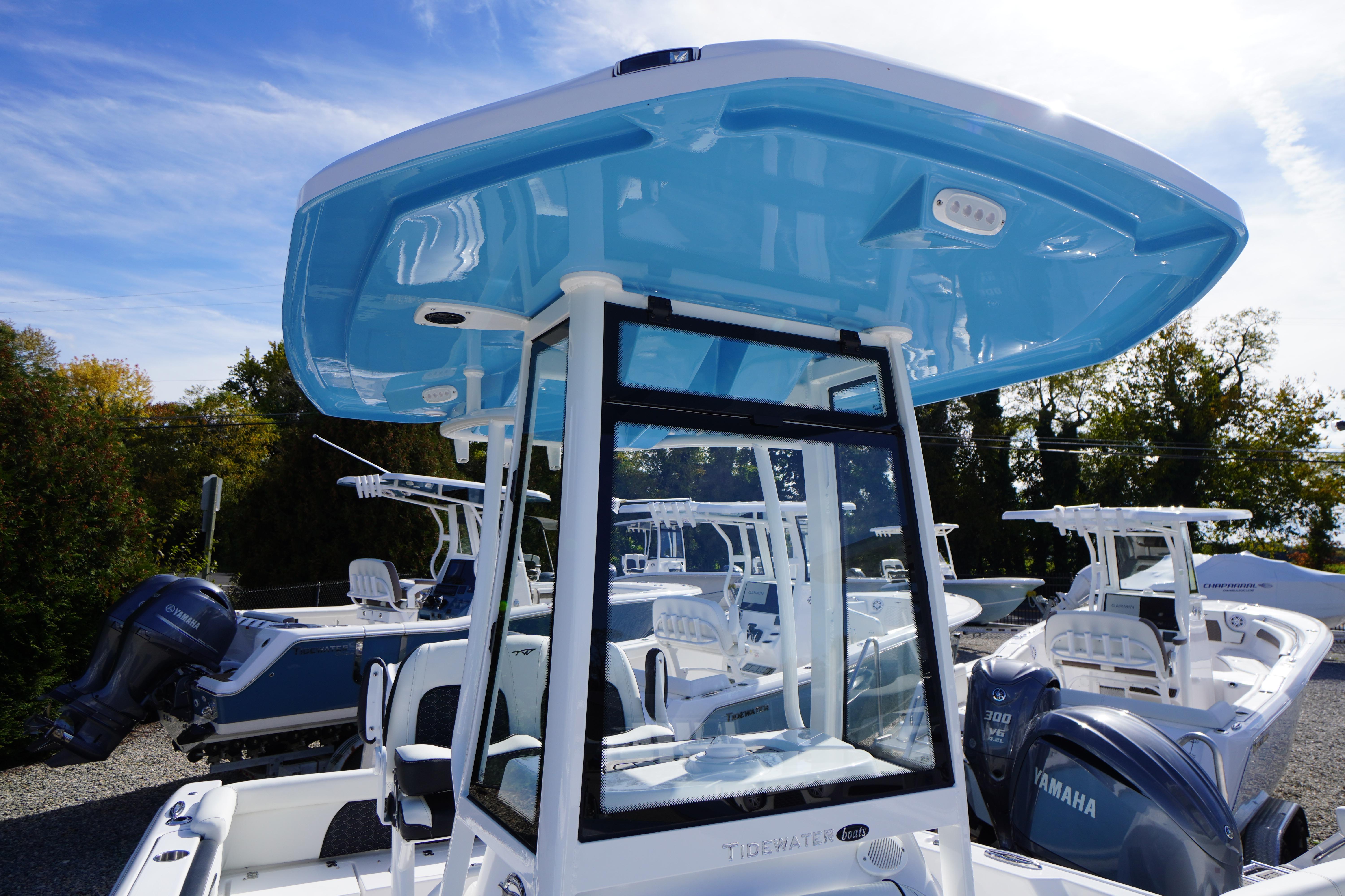 2026 Tidewater 220 LXF boat with blue T-top and Yamaha outboard engines.