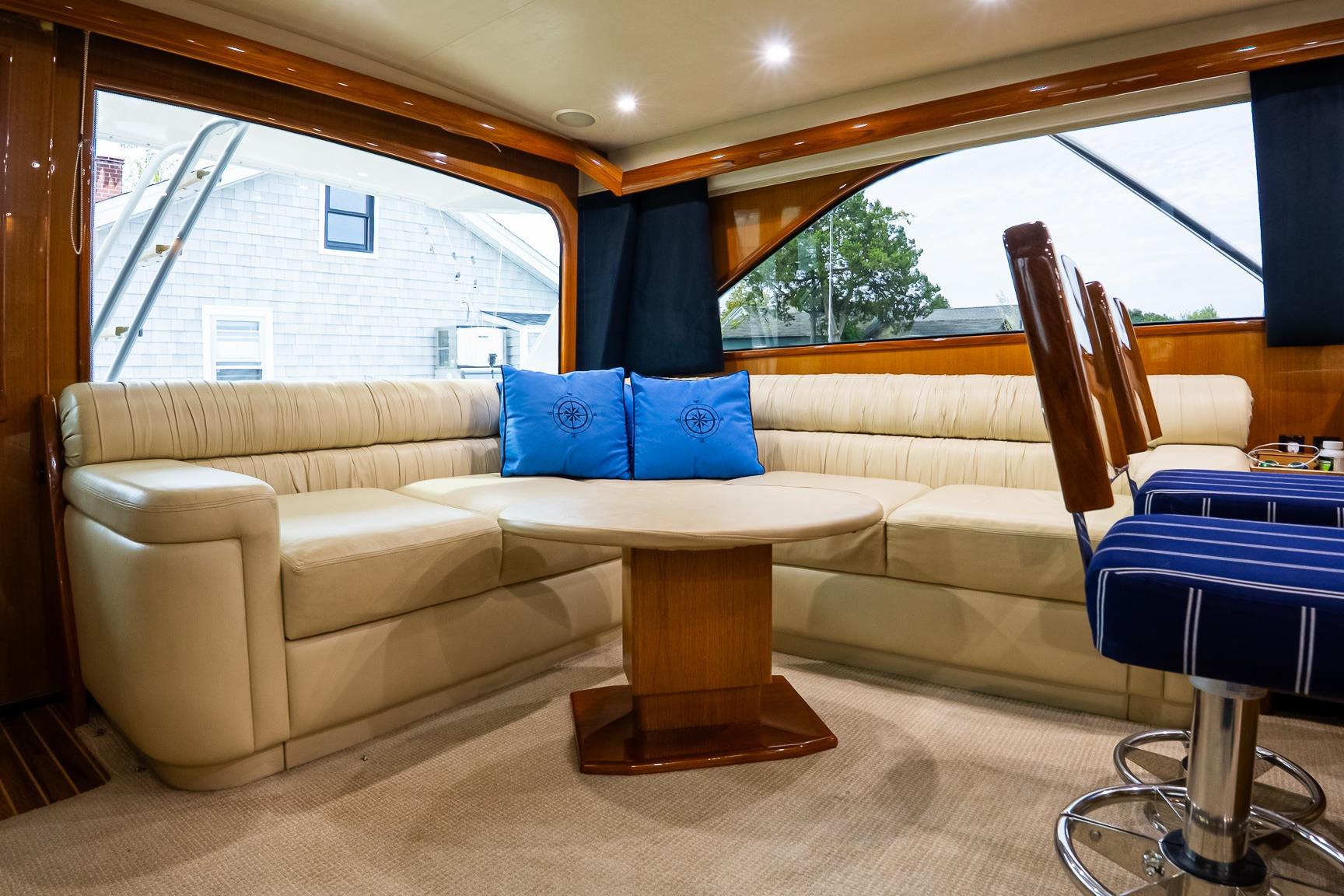 Luxurious interior of 2002 Viking 61 Enclosed Bridge yacht with plush seating and elegant decor.