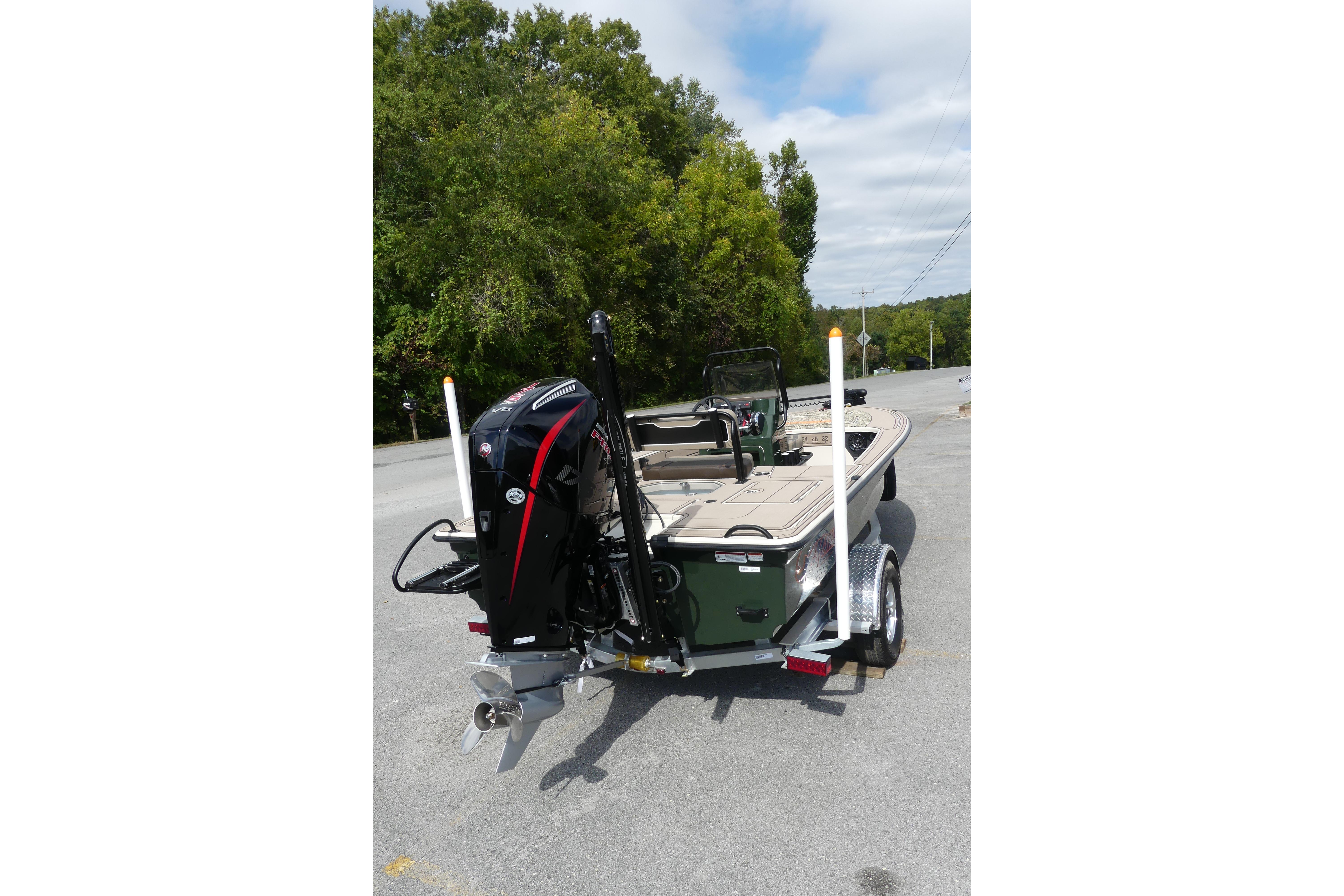 2025 Mako 18 Pro Skiff Backwater Edition boat on trailer, parked outdoors.