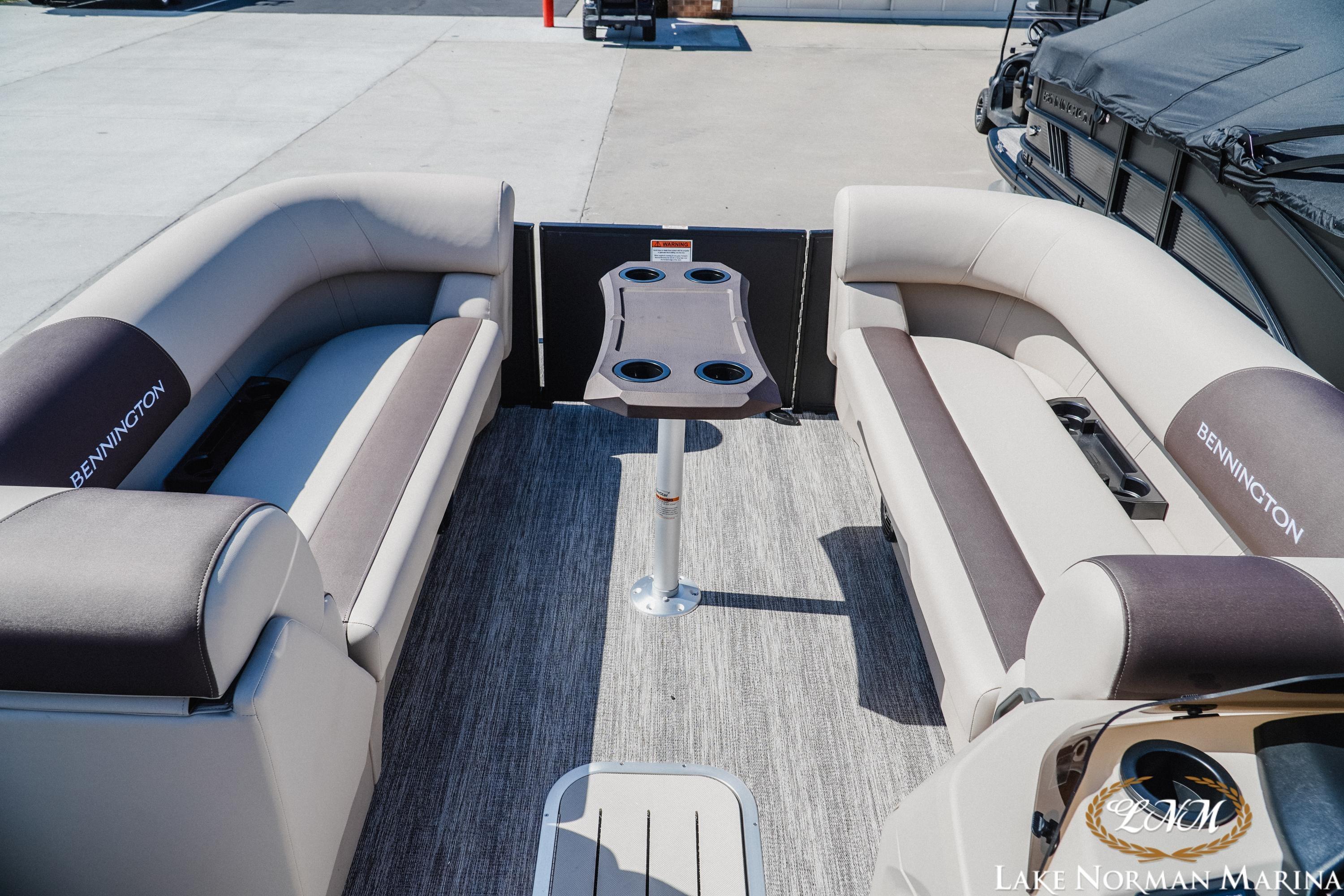 2027 Bennington 23SSB pontoon boat interior with plush seating and central table.