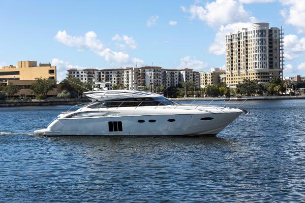 2013 Princess V57 luxury yacht on water with city buildings in background.