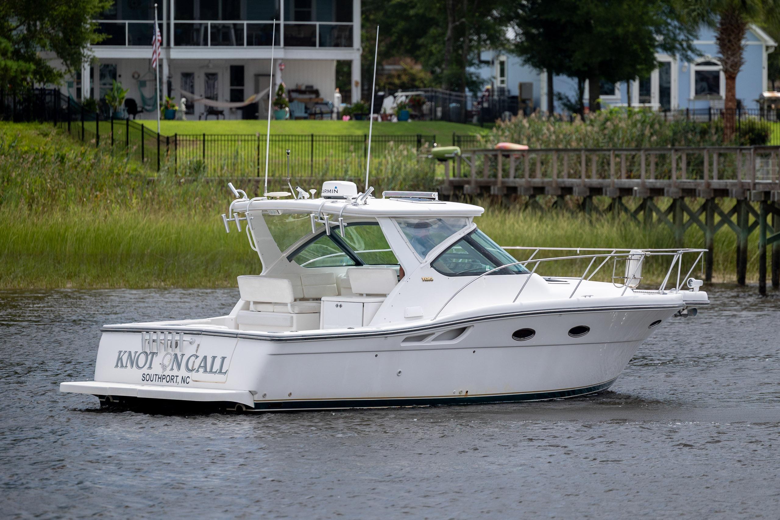 2004 Tiara Yachts 3200 Open boat on water near shoreline homes.