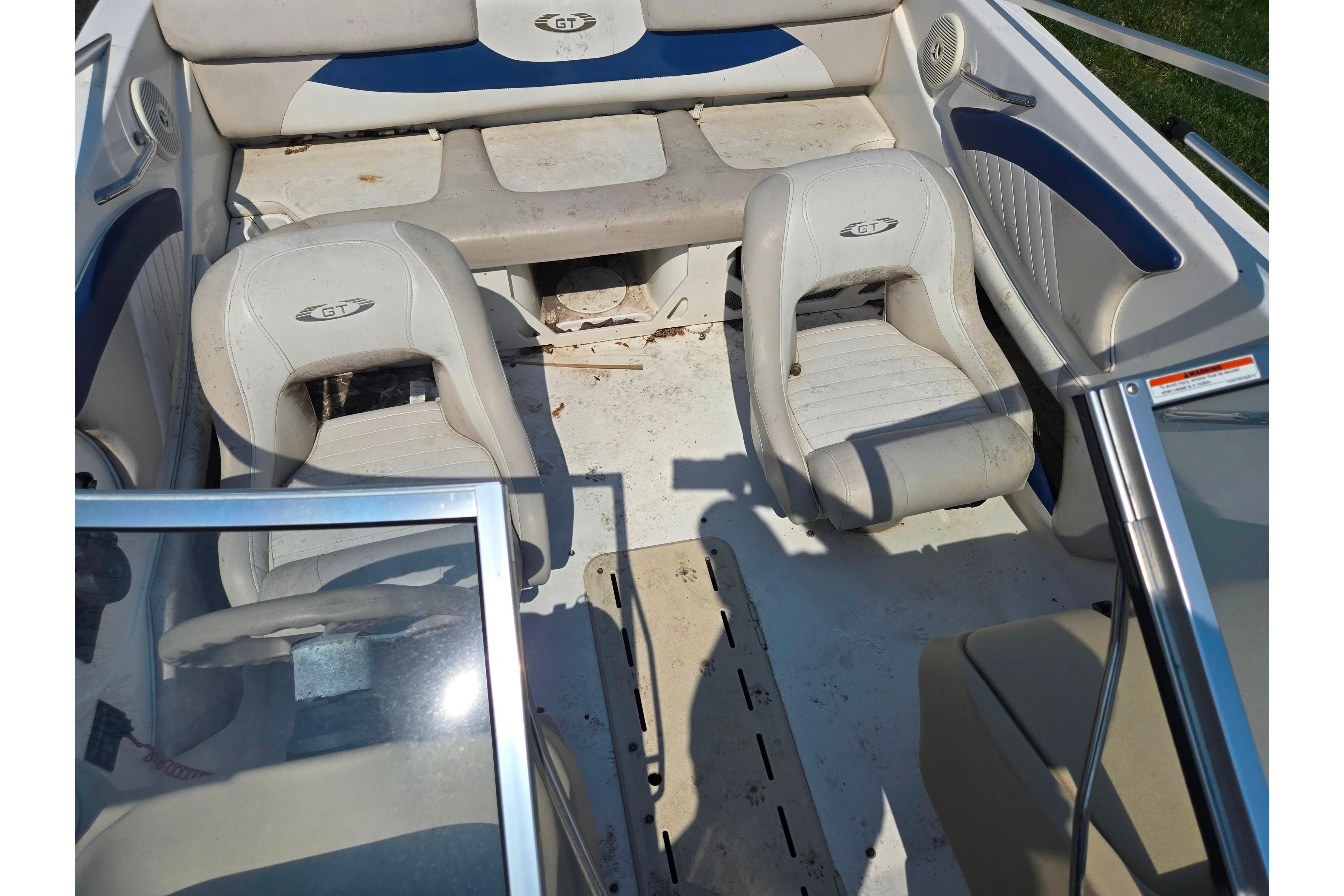 2007 Glastron GT 185 boat interior with white seating and blue accents.