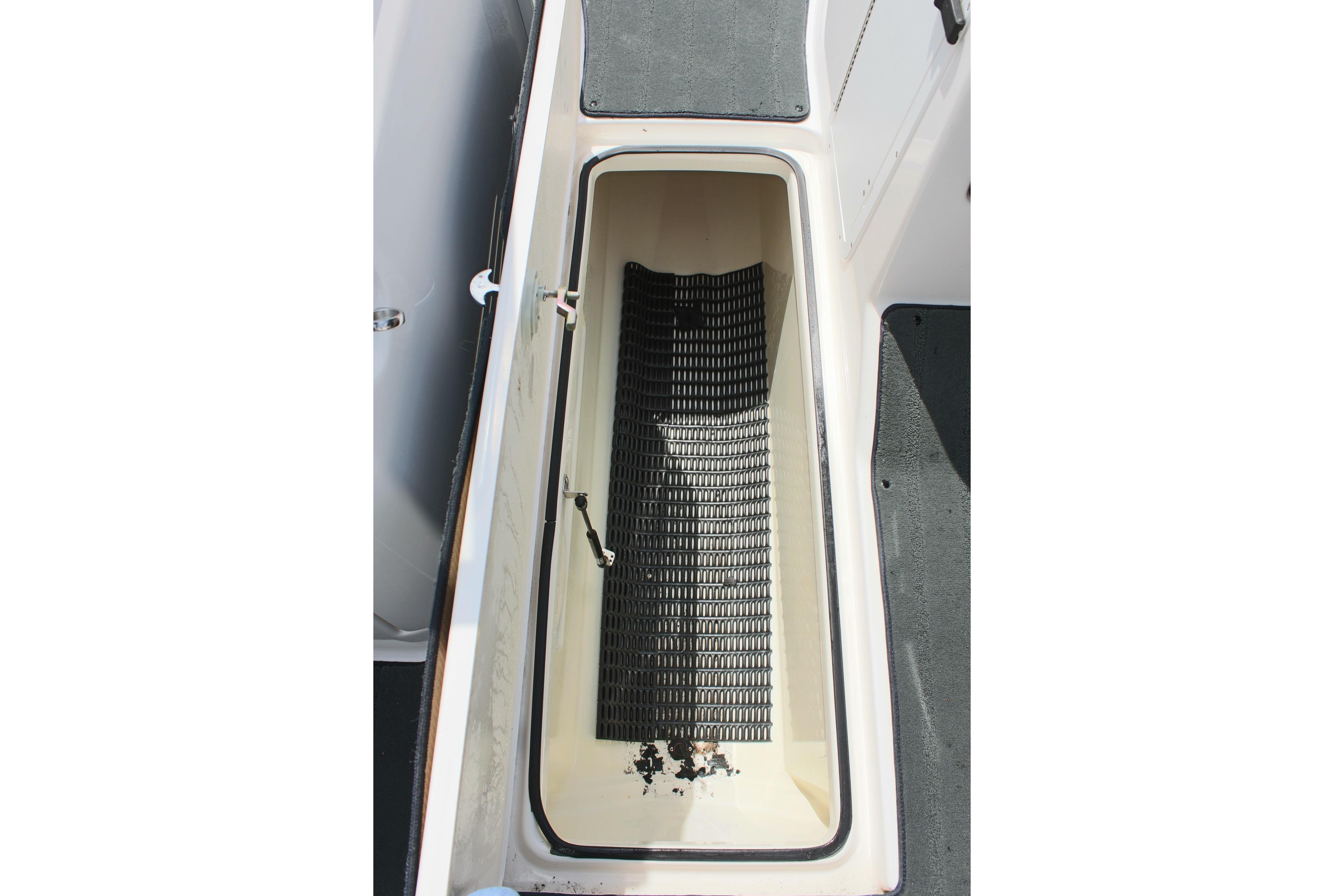 Storage compartment of 2016 Yamaha Boats 242 Limited S, featuring non-slip mat.