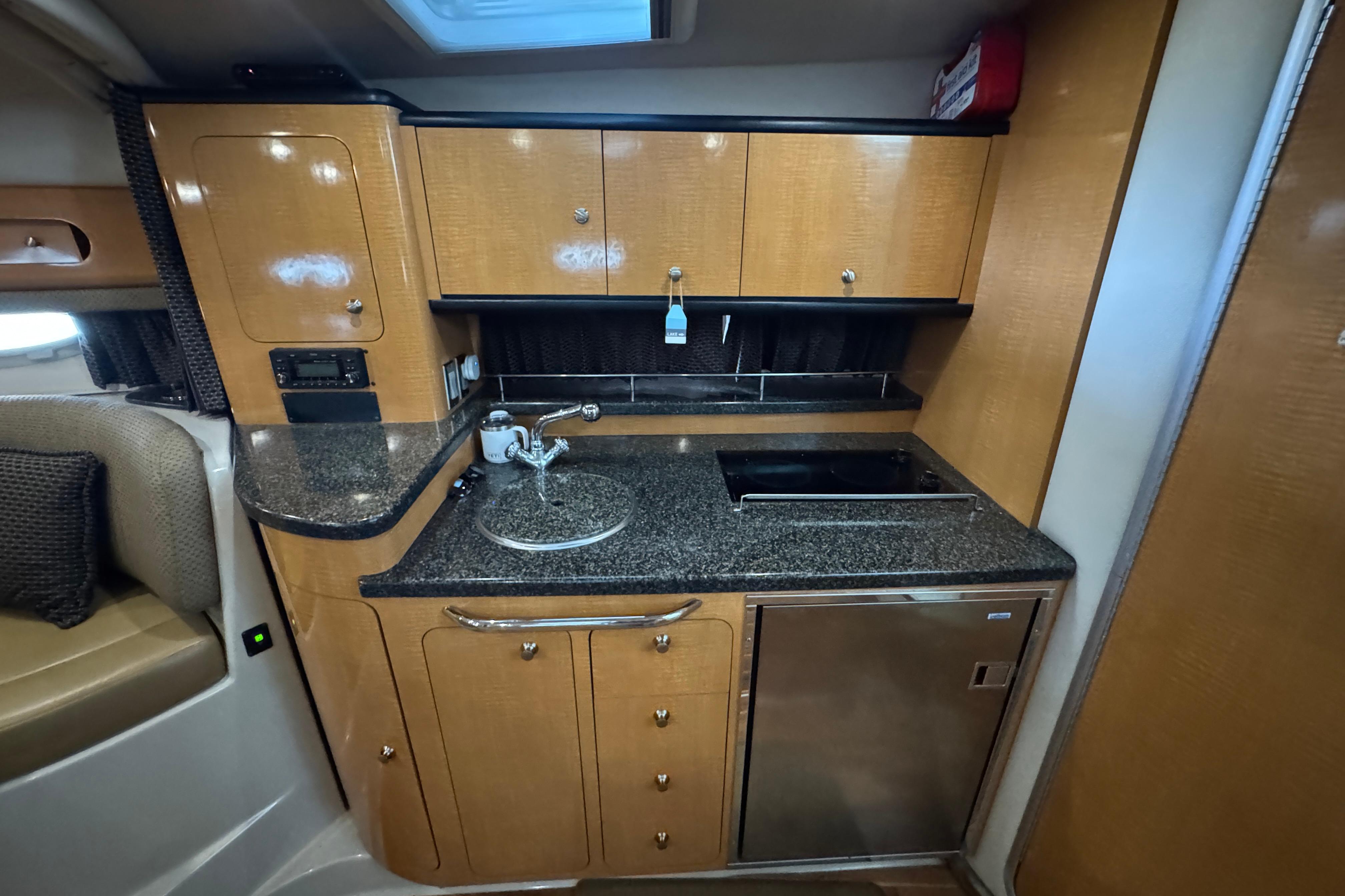 2006 Chaparral 330 Signature yacht kitchen with wood cabinets and granite countertops.