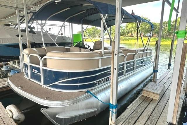 2019 Sun Tracker Party Barge 22 XP3 pontoon boat docked, featuring blue and beige design.