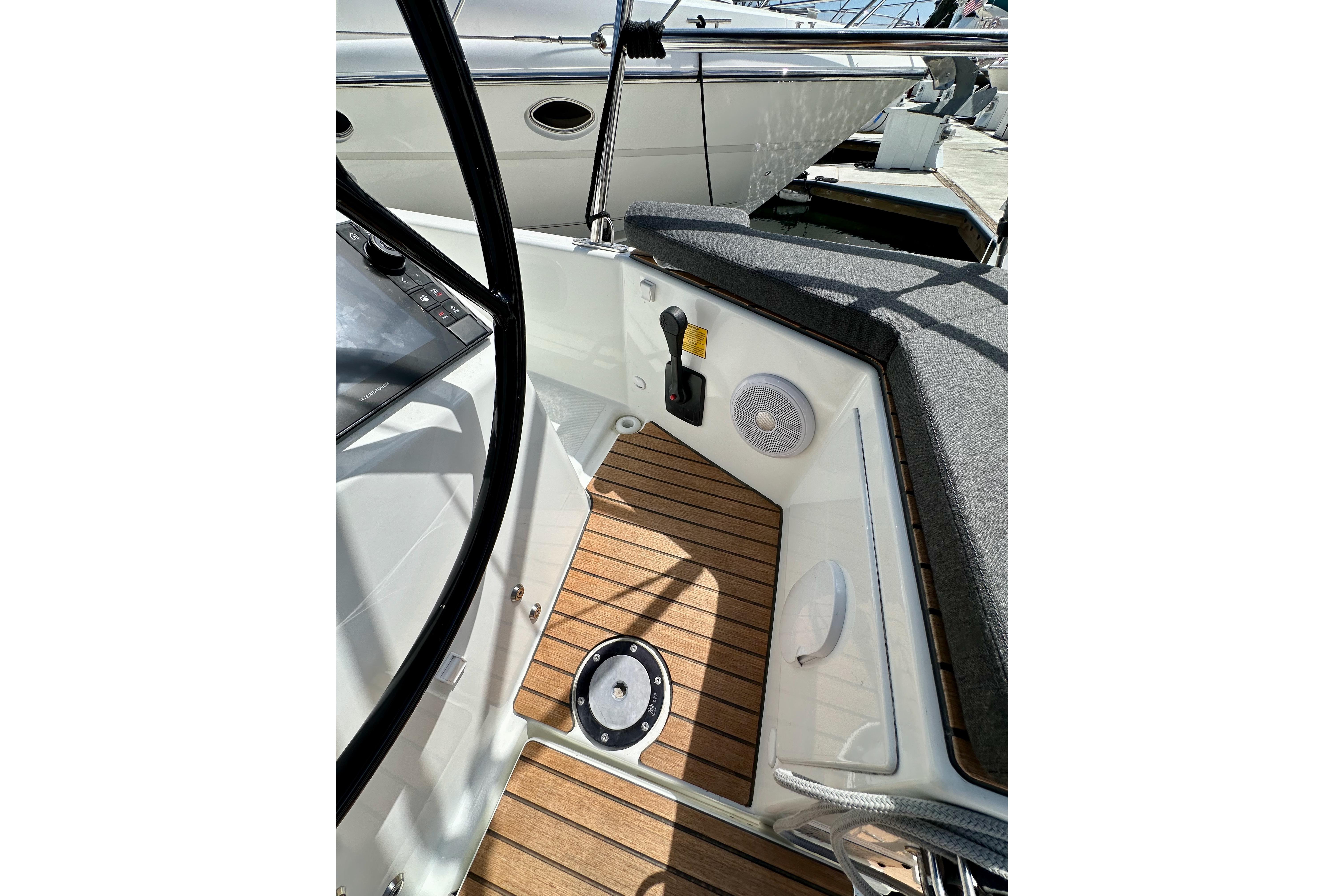 2024 Jeanneau Sun Odyssey 410 cockpit with teak flooring and modern controls.