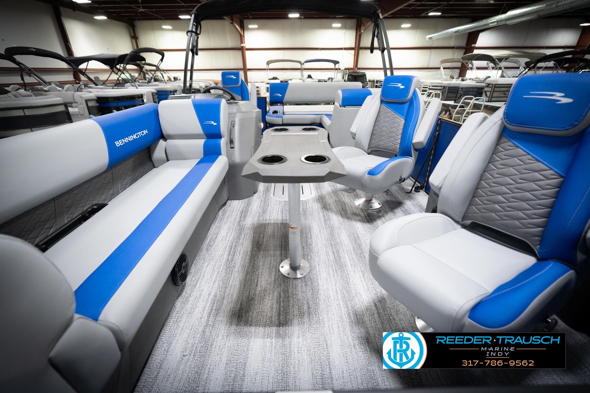 2026 Bennington 22 SSB pontoon boat interior with blue and gray seating, showroom display.