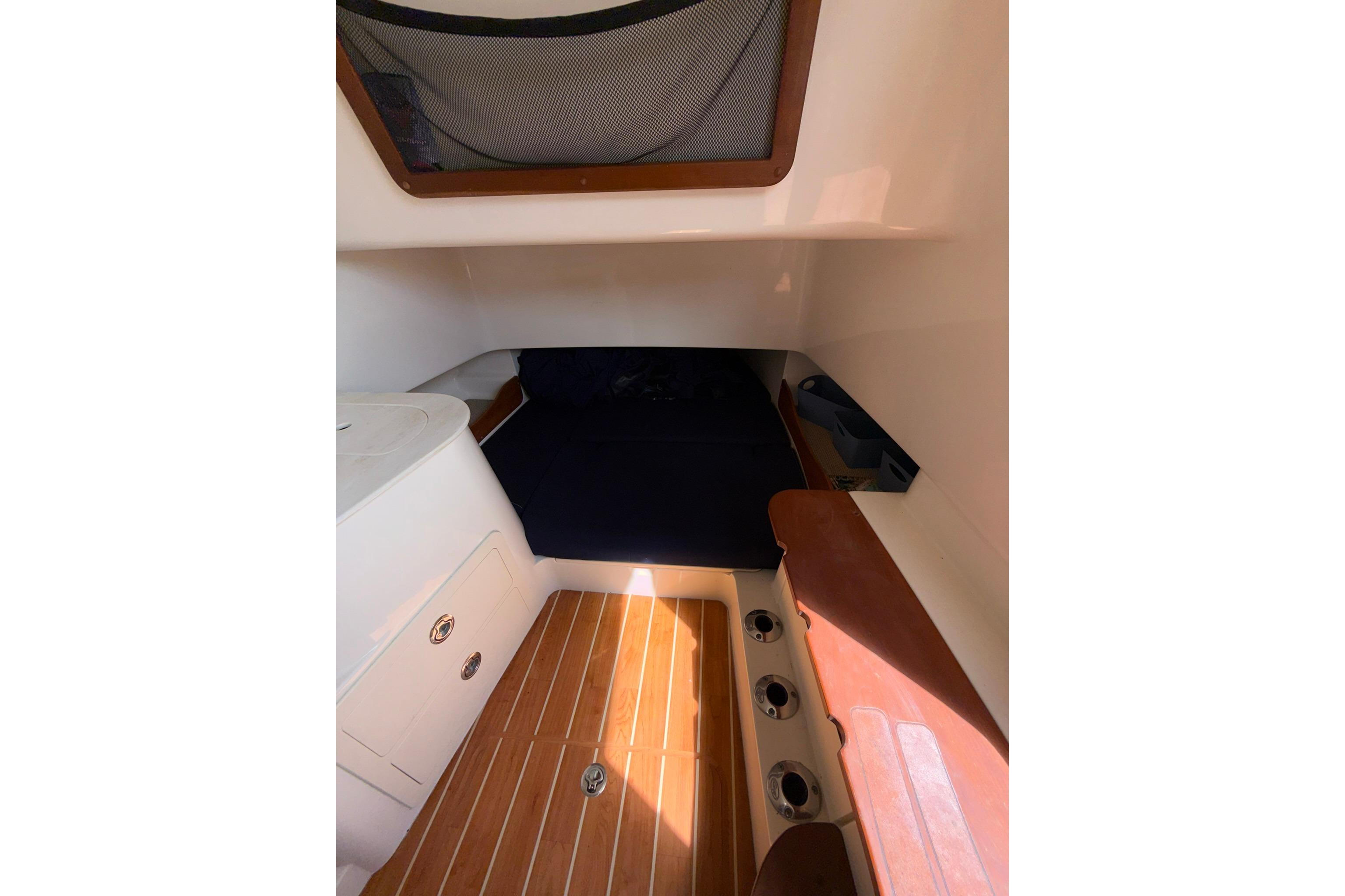 2021 Grady-White Canyon 336 cabin interior with wood flooring and storage compartments.